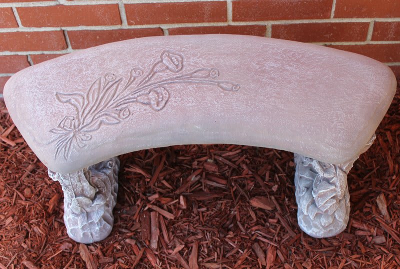 Decorative stone bench with a floral relief pattern