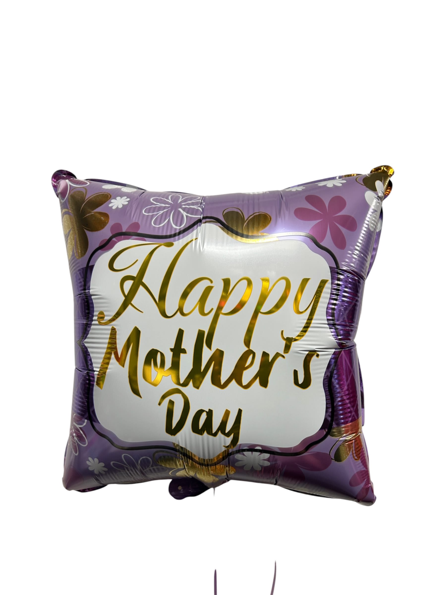 BALLON HAPPY MOTHERS  DAY  - A glossy square foil balloon announces "Happy Mother's Day" in gold lettering, framed by a soft lavender border and scattered pink, white and gold floral graphics - the perfect cheerful add-on for a Mother's Day gift. As a celebratory accent rather than a bouquet, this balloon brings instant color and festivity to a table setting, breakfast tray, or vase-topped arrangement to make the person you're honoring feel seen and celebrated.  The balloon's inflated square shape and shiny finish catch light and draw the eye among purple, white, pink and yellow blooms. It pairs beautifully with mixed bouquets in coordinating pastels or stands alone on a weighted ribbon for delivery. Add it to your order at checkout to complete a meaningful Mother's Day surprise; no special care is needed beyond keeping it indoors and away from sharp objects.