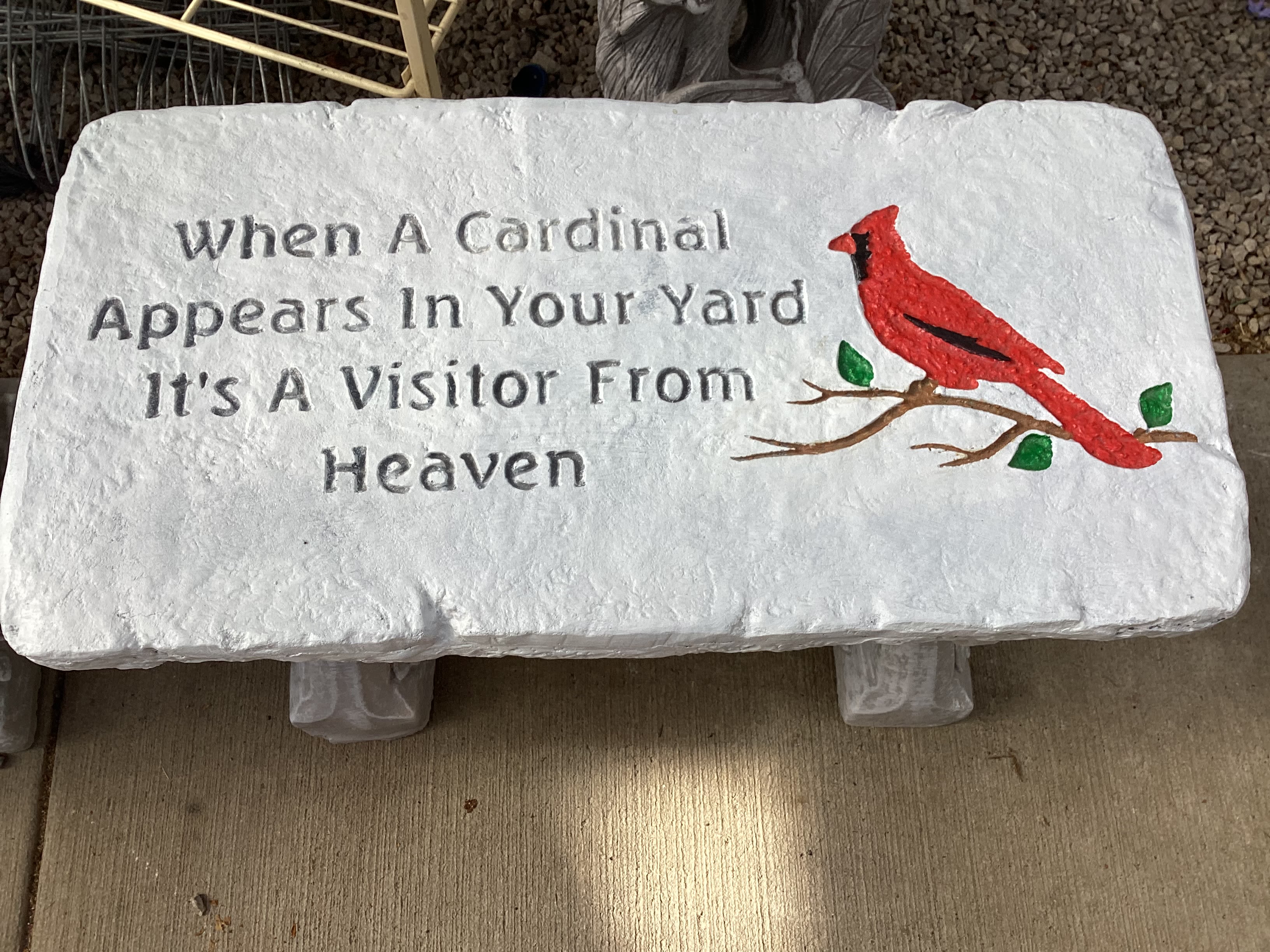 White memorial plaque with a red cardinal and engraved text