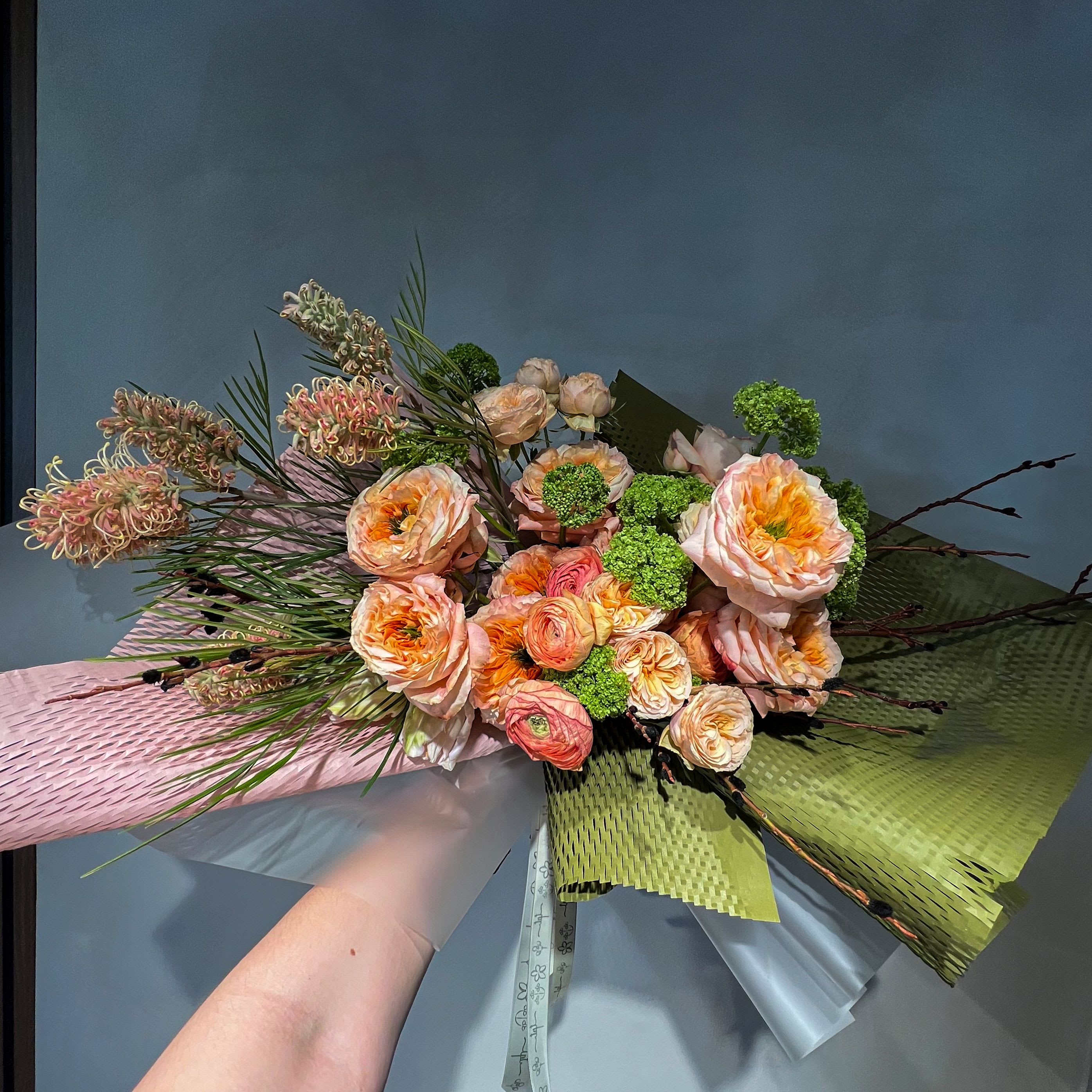 For Eomeoni in Peach  - A soft, all-peach bouquet composed in layered tones  - bringing together seasonal and classic flowers in a warm, gentle palette. Designed intuitively, each arrangement is one of a kind, allowing texture, movement, and color to shape the final form.  What’s Included:  – Seasonal flowers in peach tones – Handwritten note + care instructions – Carry-out bag – Water source to keep stems fresh – Bouquets with 18+ stems include a water pouch for transport  Please Note:  Images are for inspiration only. We do not replicate past designs or recreate another florist’s work. Each bouquet is uniquely handcrafted with care and intention.