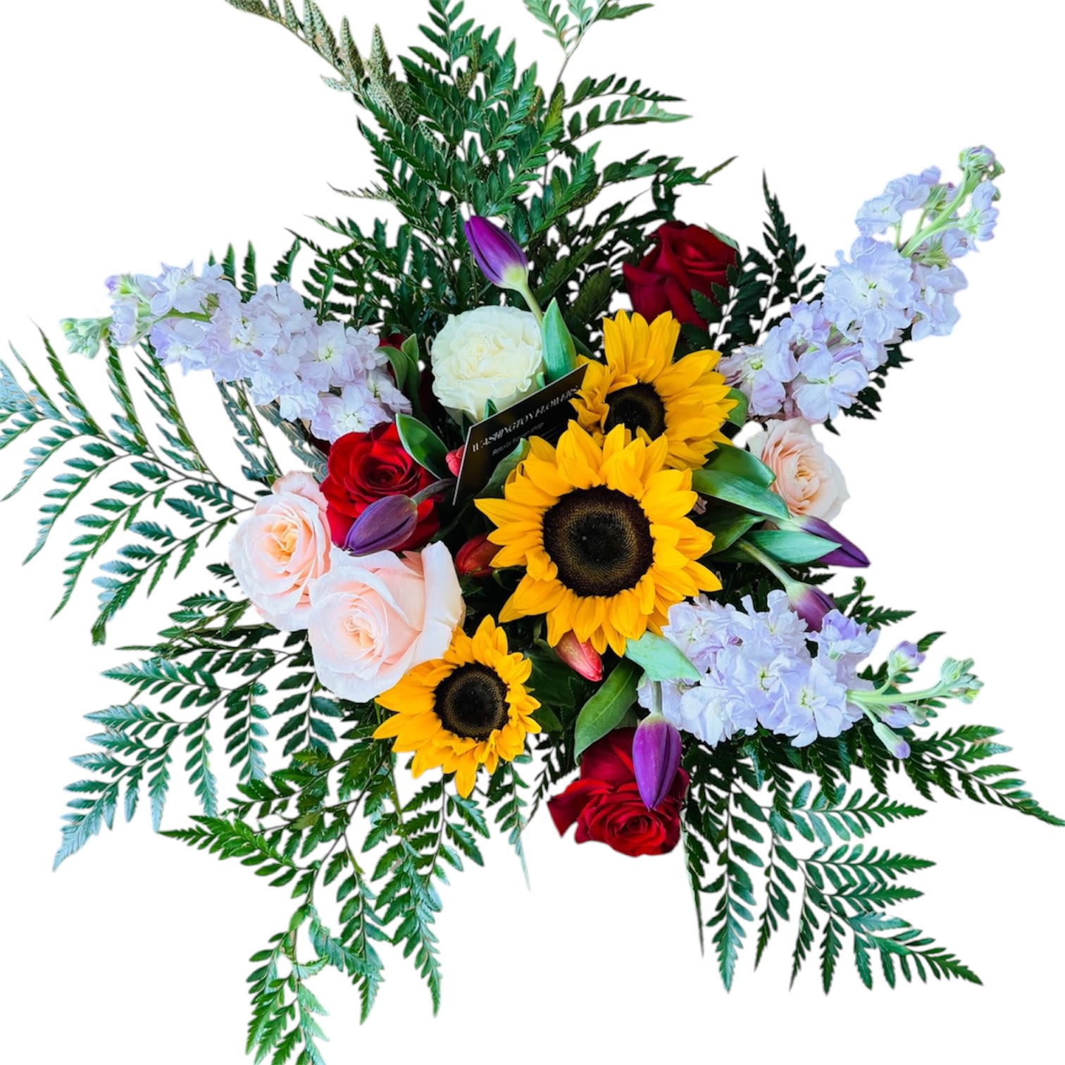 Mother’s Day Sunshine  - A vibrant floral arrangement featuring bright yellow sunflowers, red and blush roses, soft lavender blooms, and purple tulips surrounded by lush green foliage.  The bouquet creates a fresh, elegant, and cheerful look with a perfect balance of bold and soft colors. 