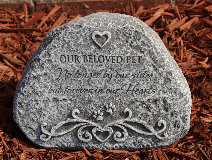 Memorial stone engraved with "Our Beloved Pet" and a heart design