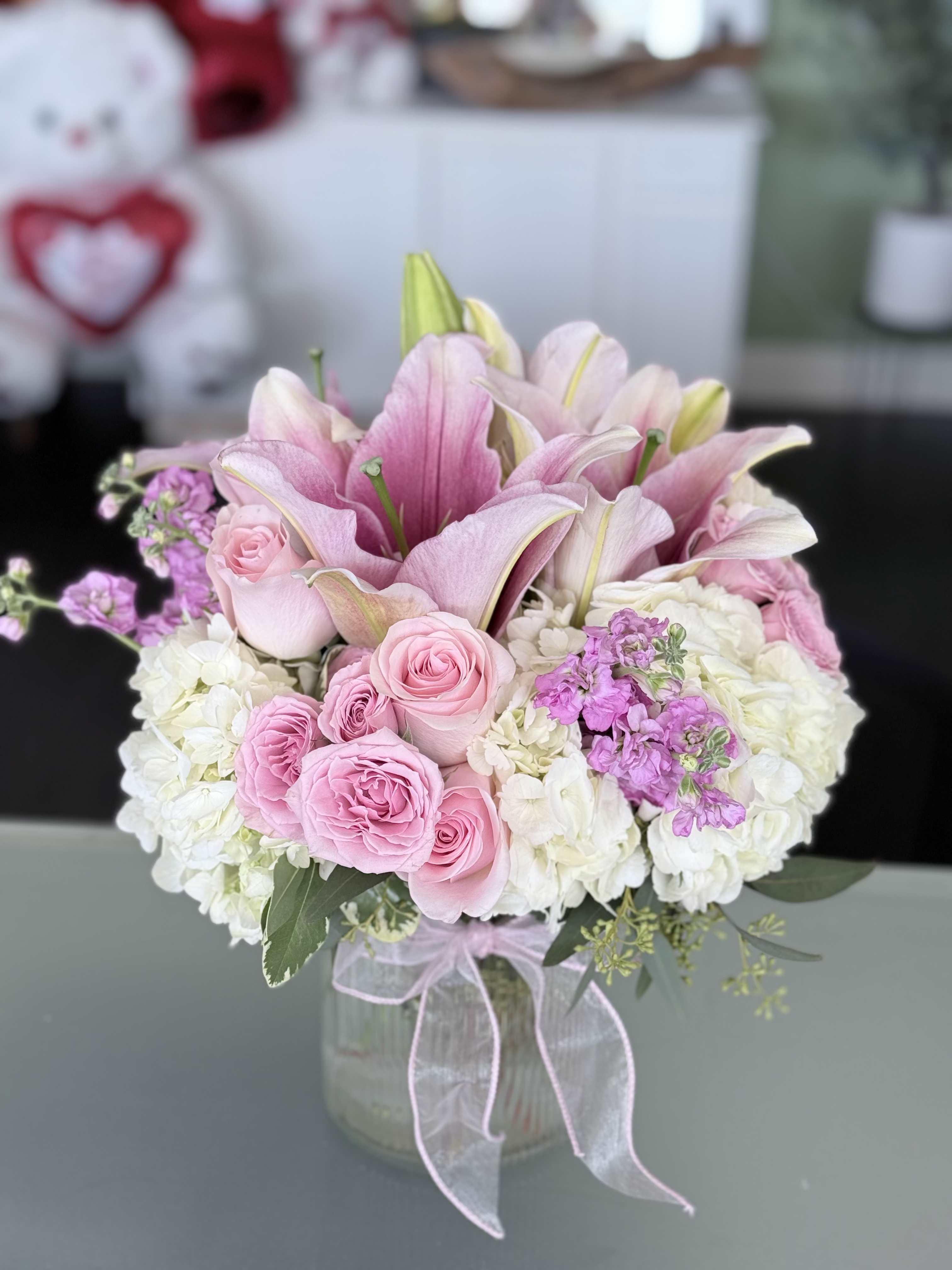 Magic - Pink Oriental Lilly’s, white Hydrangeas, Pink Roses, Light Pink Spray Roses, Coffee Beans. 