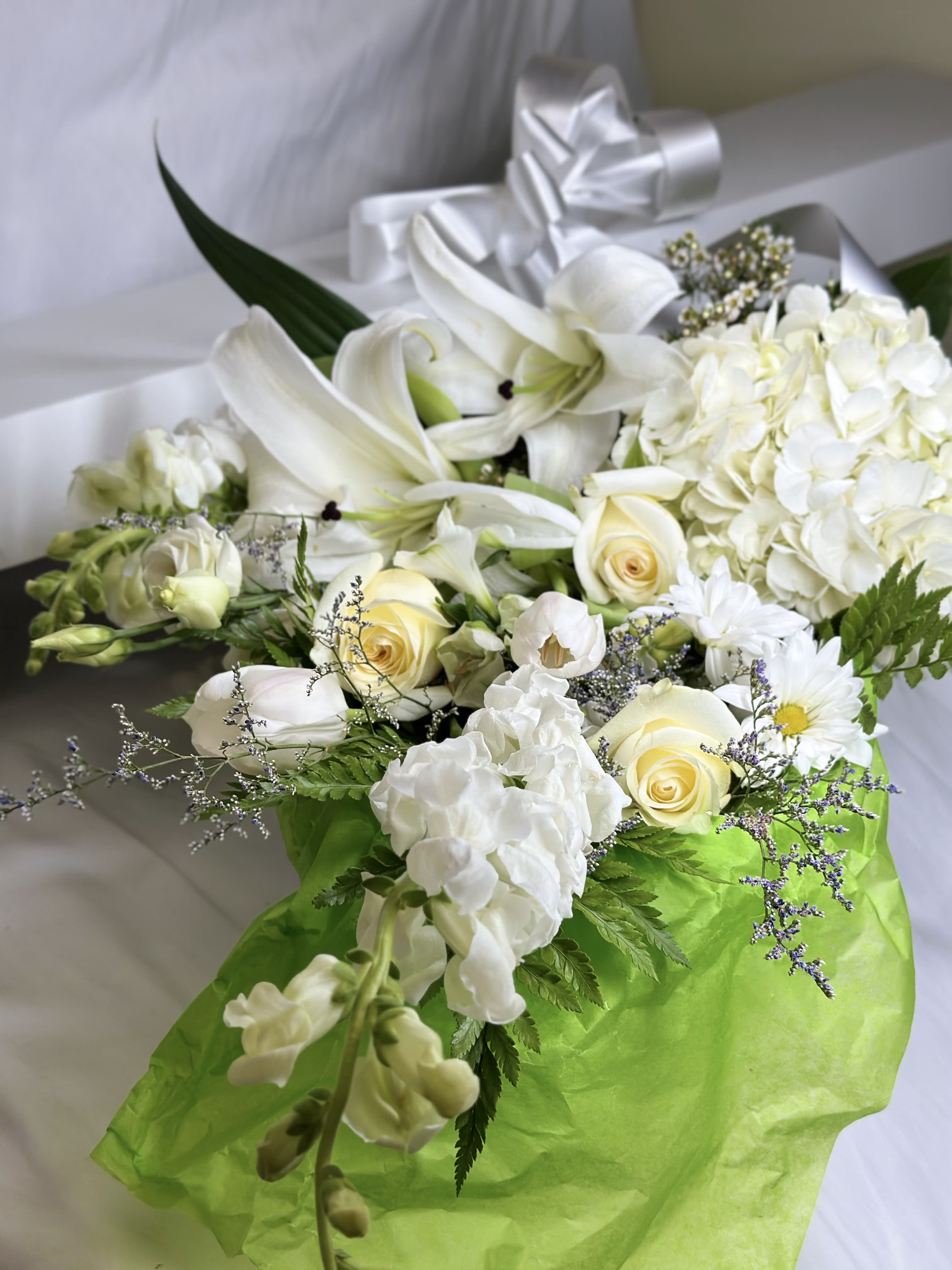 The White Box - If you want to bring joy to someone, just send a boxed bouquet of the loveliest flowers around! We will curate the freshest seasonal blooms in pretty shades of white, cream, and ivory! Each hand designed grouping will be unique. The pictured flowers are an example of the lovely blossoms we incorporate into a lavish boxed presentation with a coordinating ribbon. PLEASE NOTE, no vase is included