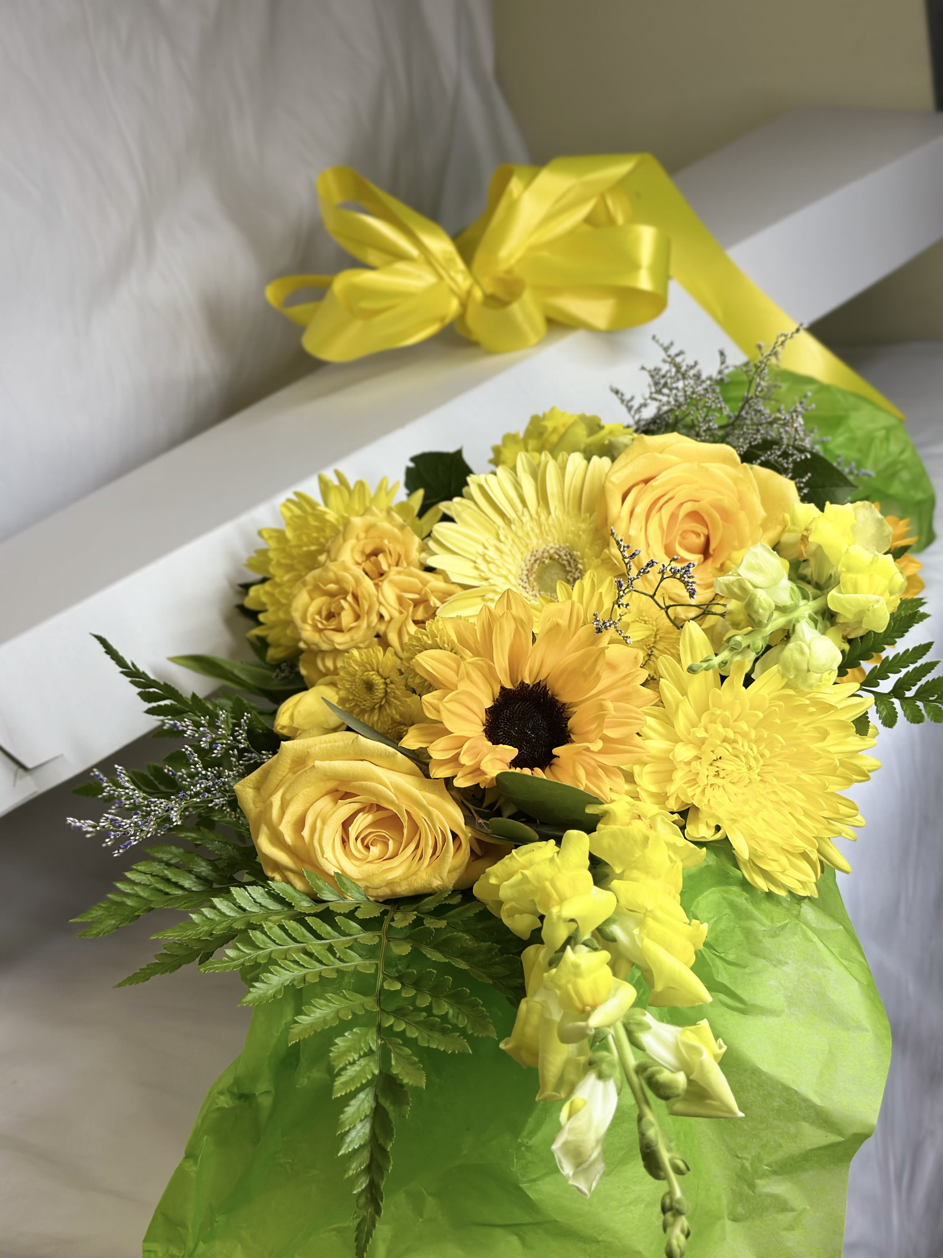 The Yellow Box - If you want to bring joy to someone, just send a boxed bouquet of the loveliest flowers around! We will curate the freshest seasonal blooms in stunning shades of sunny yellow! Each hand designed grouping will be unique. The pictured flowers are an example of the lovely blossoms we incorporate into a lavish boxed presentation with a coordinating ribbon. PLEASE NOTE, no vase is included
