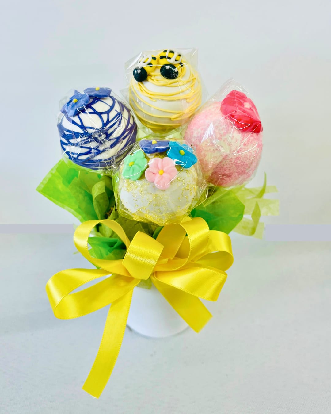 Buzz &amp; Bloom Pops - Buzz &amp; Bloom Pops are a charming blend of sweetness and springtime beauty, featuring handcrafted cake pops topped with delicate florals and pollinator-inspired designs. Each pop is made from moist, flavorful cake and coated in a smooth candy shell, then finished with artistic details like bees, butterflies, and blooming petals. Perfect for birthdays, baby showers, weddings, garden parties, or simply brightening someone’s day, these treats bring a touch of nature-inspired elegance to any occasion.  Available for local delivery in Smyrna, Mableton, Marietta, Austell, and Atlanta, Buzz &amp; Bloom Pops are as delightful to gift as they are to enjoy.