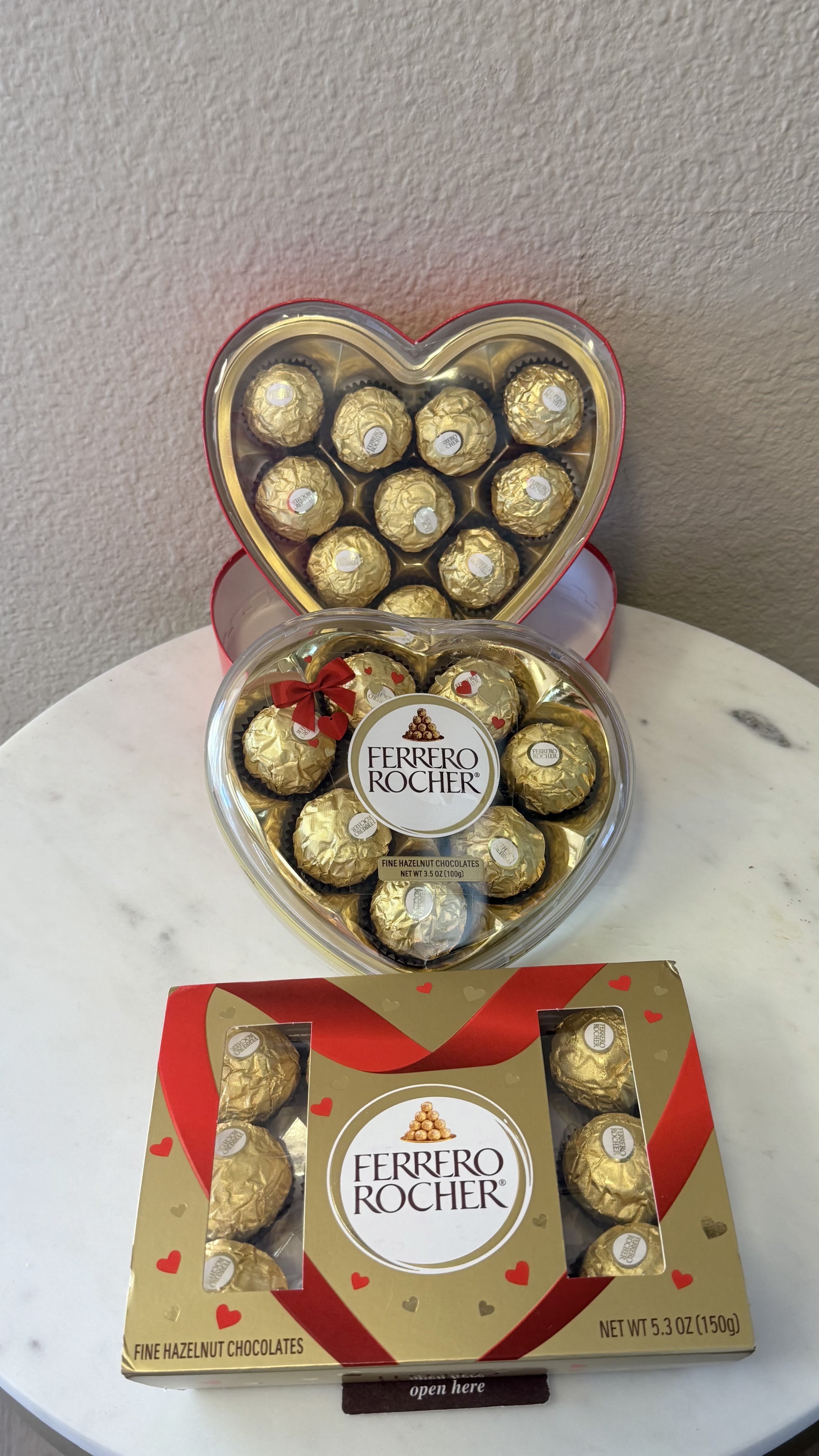 Heart-shaped boxes of Ferrero Rocher chocolates on a table