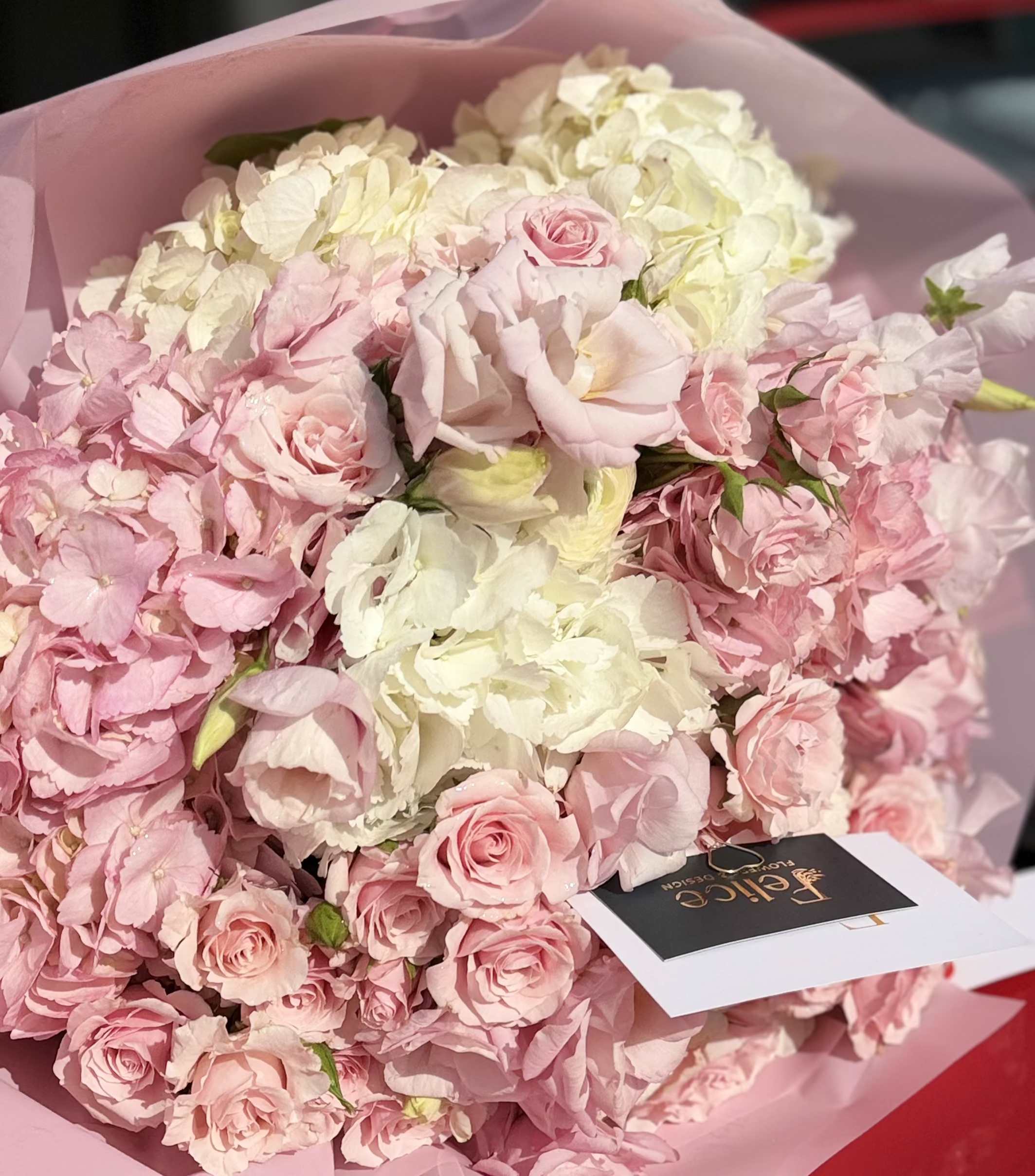 Blush Hydrangea Garden Bouquet - A soft and luxurious flower bouquet designed in delicate blush pink and creamy white tones, featuring premium hydrangeas, roses, spray roses, and seasonal garden blooms. This arrangement captures a romantic garden-inspired aesthetic with full textures, airy composition, and elegant wrapping. The gentle color palette creates a feeling of softness, femininity, and refined beauty. Perfect for Birthday, Anniversary, Baby Shower, Thank You, Get Well, and Just Because moments. Please note: due to seasonal availability, some flowers may be substituted. However, the overall color palette, bouquet size, and elegant garden style will remain consistent with the photo. Handcrafted by Felice Flowers &amp; Design.
