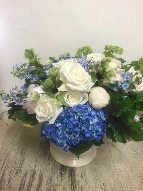 Blue Bayou - Low arrangement of blue hydrangea, roses, peonies, viburnum