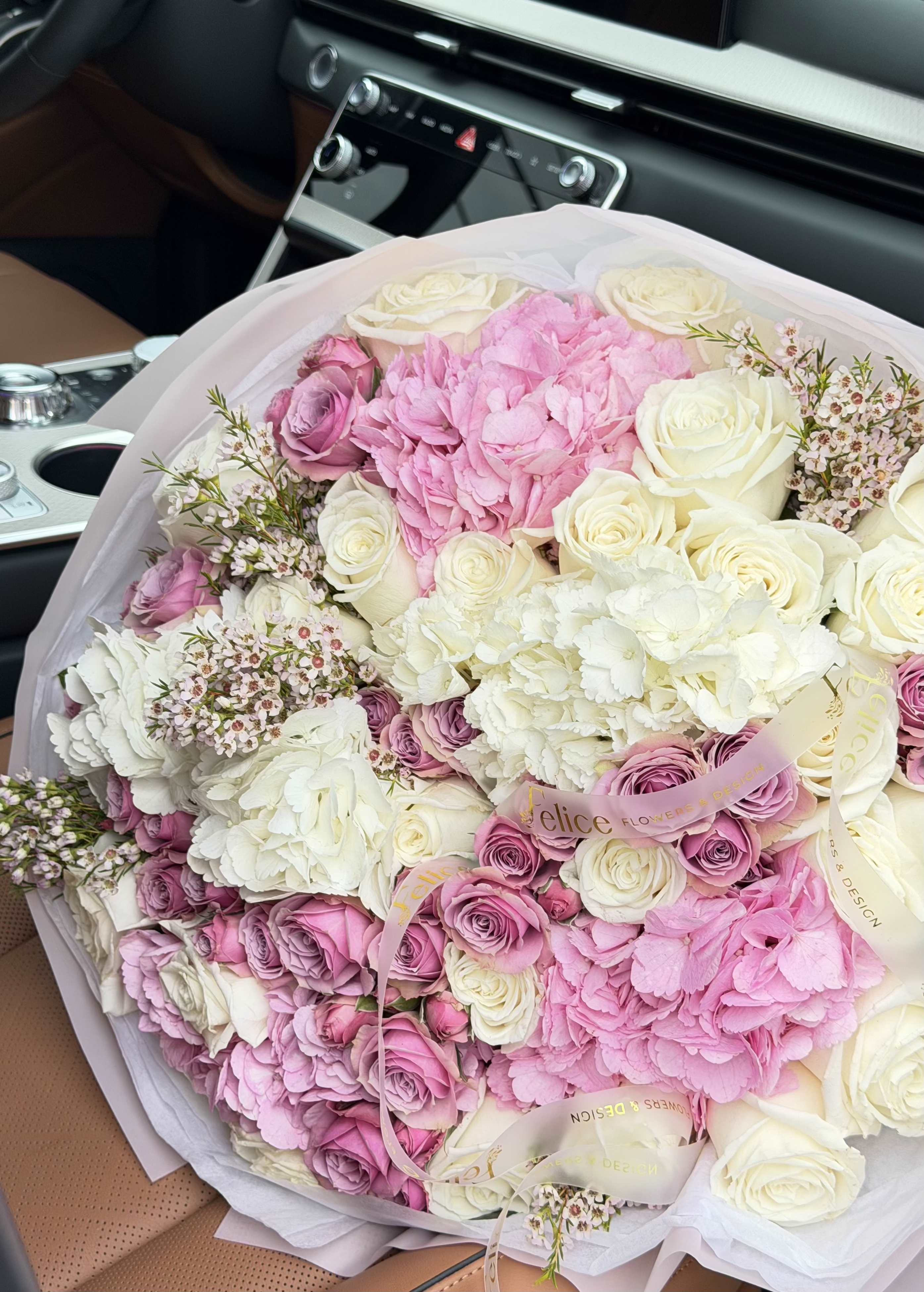 Blush Elegance Luxury Bouquet - An exquisite luxury bouquet designed in soft blush pink and ivory tones, featuring premium roses, spray roses, and lush hydrangeas. This arrangement is crafted in a full, round garden style with rich texture and elegant layering, creating a romantic and timeless look. The soft pastel palette adds a delicate and sophisticated touch, perfect for meaningful moments. Wrapped in premium white paper and finished with signature ribbon, this bouquet reflects the refined aesthetic of Felice Flowers &amp; Design. Perfect for Birthday, Anniversary, Romance, Congratulations, Thank You, and Just Because. Please note: due to seasonal availability, some flowers may be substituted. However, the overall color palette, size, and luxury style will remain consistent with the photo.