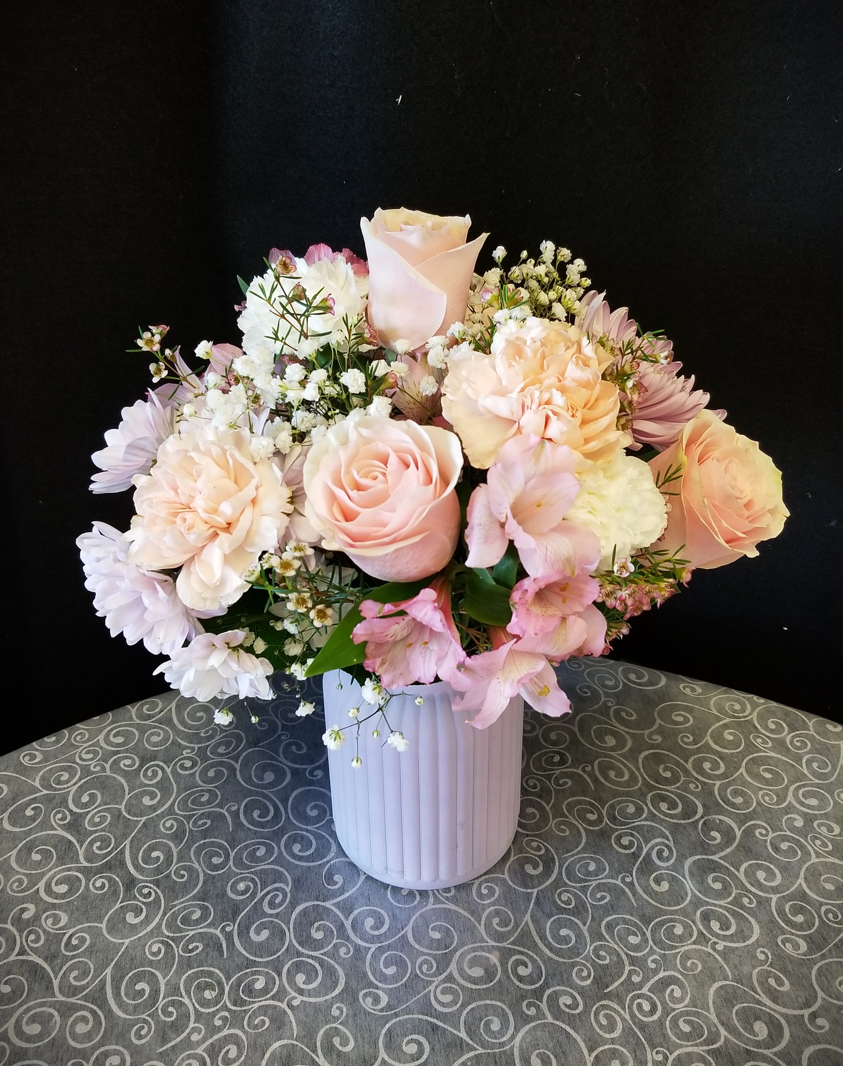 Pink Garden Vase - A mixed bouquet in soft shades of pink, peach, and white in a pale pink vase. Perfect for springtime!