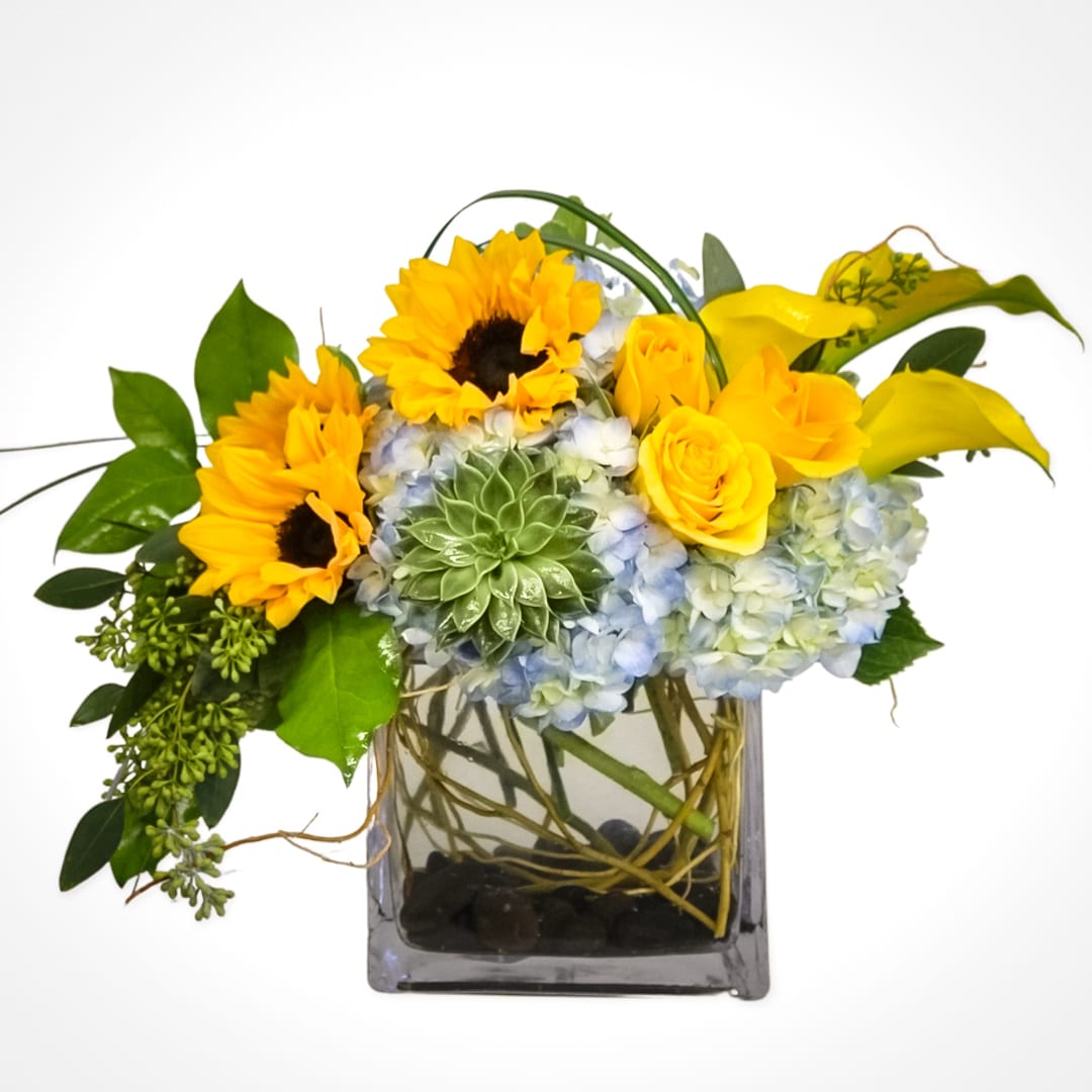 Sunny Days  - Full of sunshine. This arrangement includes hydrangea, sunflowers, roses, calla lilies, succulents, and seeded eucalyptus. 