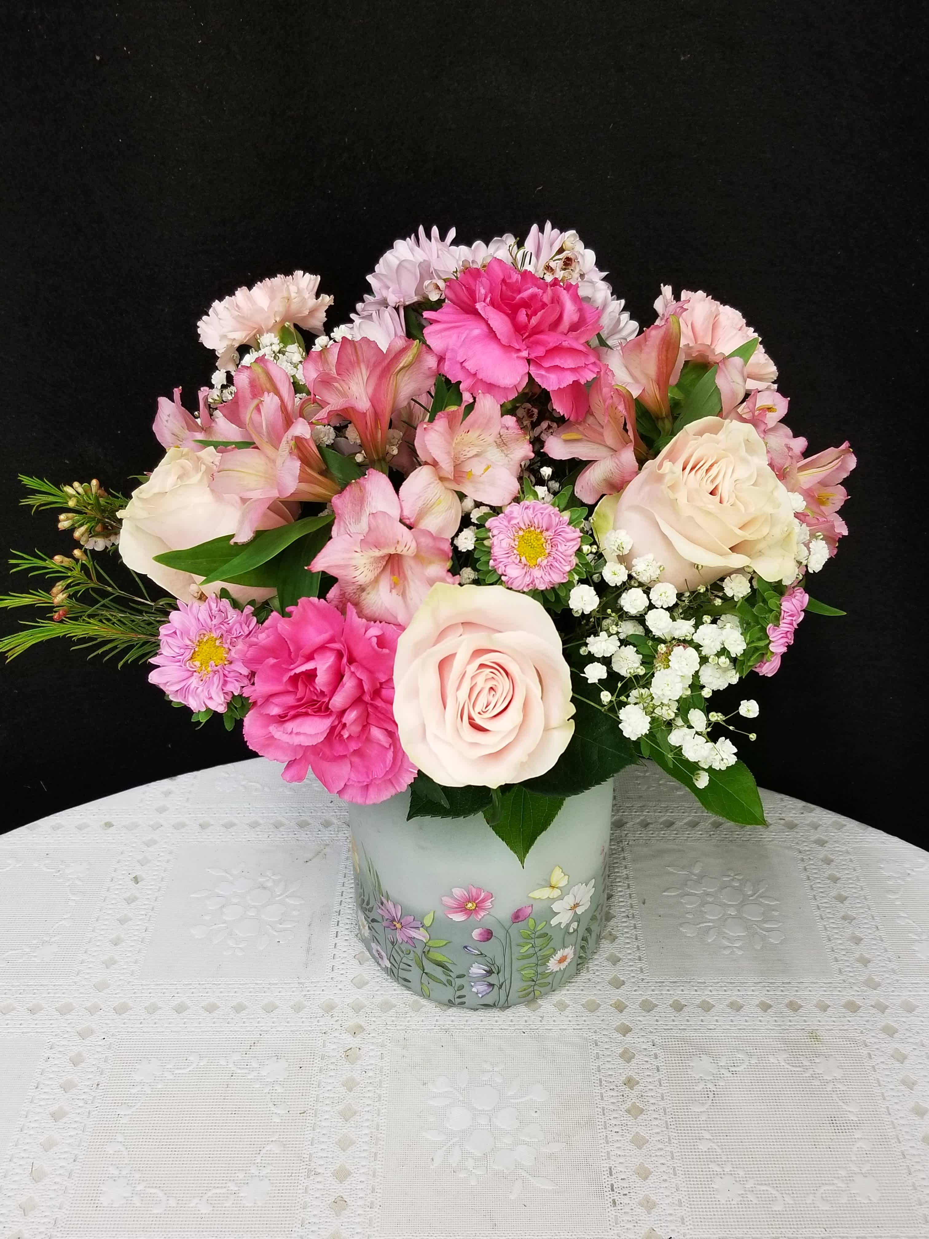 Pink and white mixed flower arrangement in a decorative vase