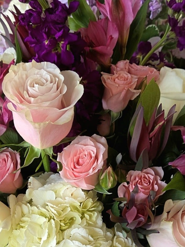 Bouquet of pink and white roses with purple flowers
