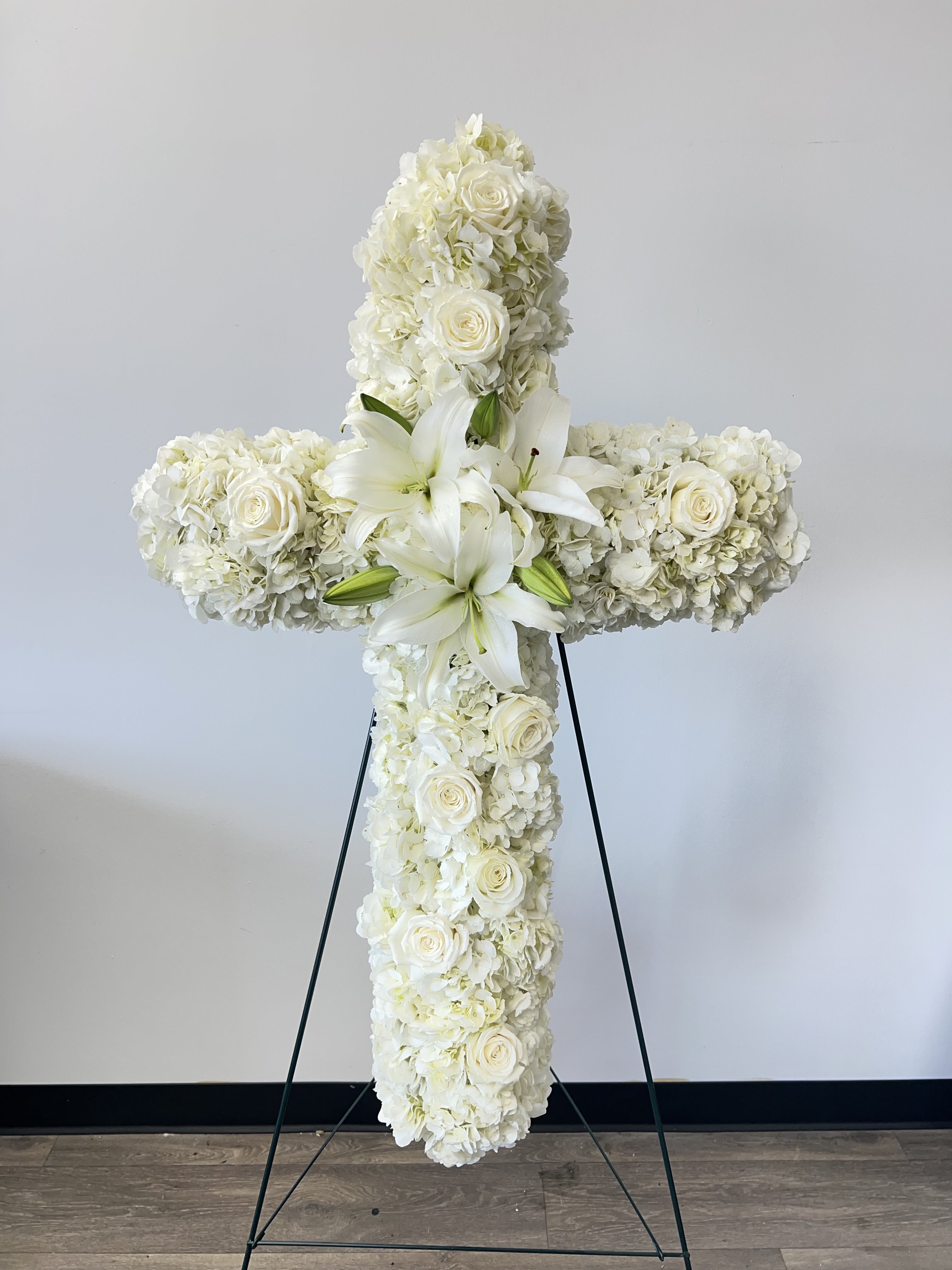 Faith by BloomNation™  - An all white tribute, this white cross funeral spray is pure and tranquil. Featuring a variety of white flowers, this elegant easel compliments the beauty of life. 