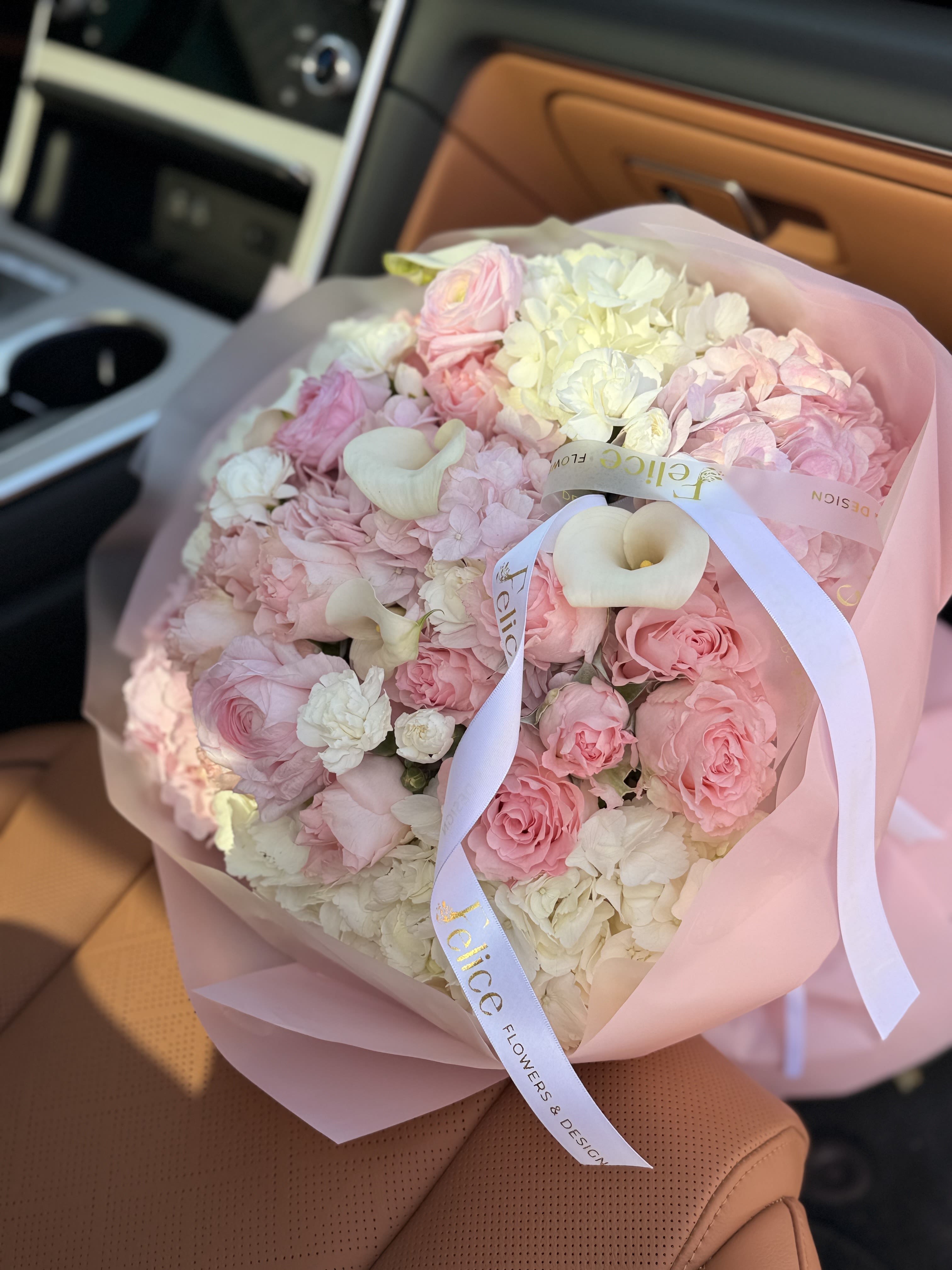 Blush Hydrangea &amp; Rose Bouquet - A luxurious and full bouquet featuring soft blush pink roses, hydrangea, and elegant white calla lilies. Designed in a classic round shape, this arrangement is rich, dense, and visually stunning. The combination of delicate pink tones with creamy white accents creates a timeless and sophisticated look. Finished with premium wrapping and signature Felice Flowers &amp; Design ribbon, this bouquet is perfect for creating a memorable impression. Ideal for Birthday, Anniversary, Romantic occasions, or elegant gifting. Please note: flower varieties may vary due to seasonality while maintaining the same color palette and full, lush style.