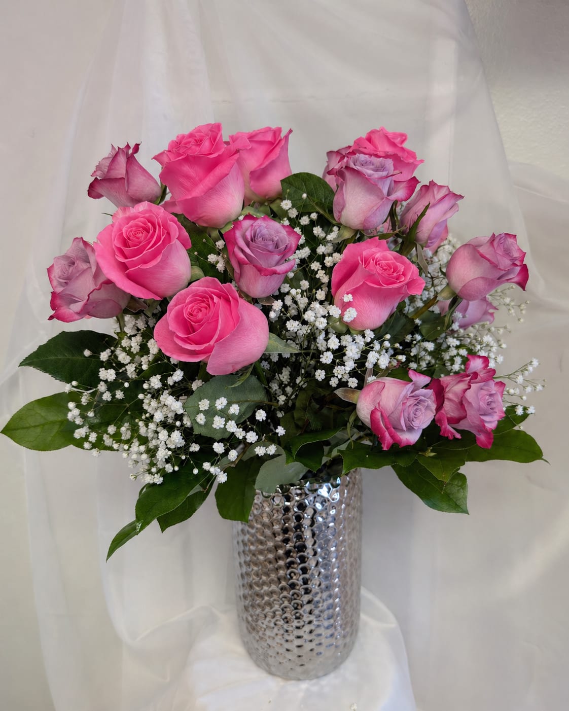 2 Dozen Mix Roses (Mother's Day edition) - 12 deep purple roses, and 12 sweet unique roses surrounded by baby's breath and foliage in a modern vase.