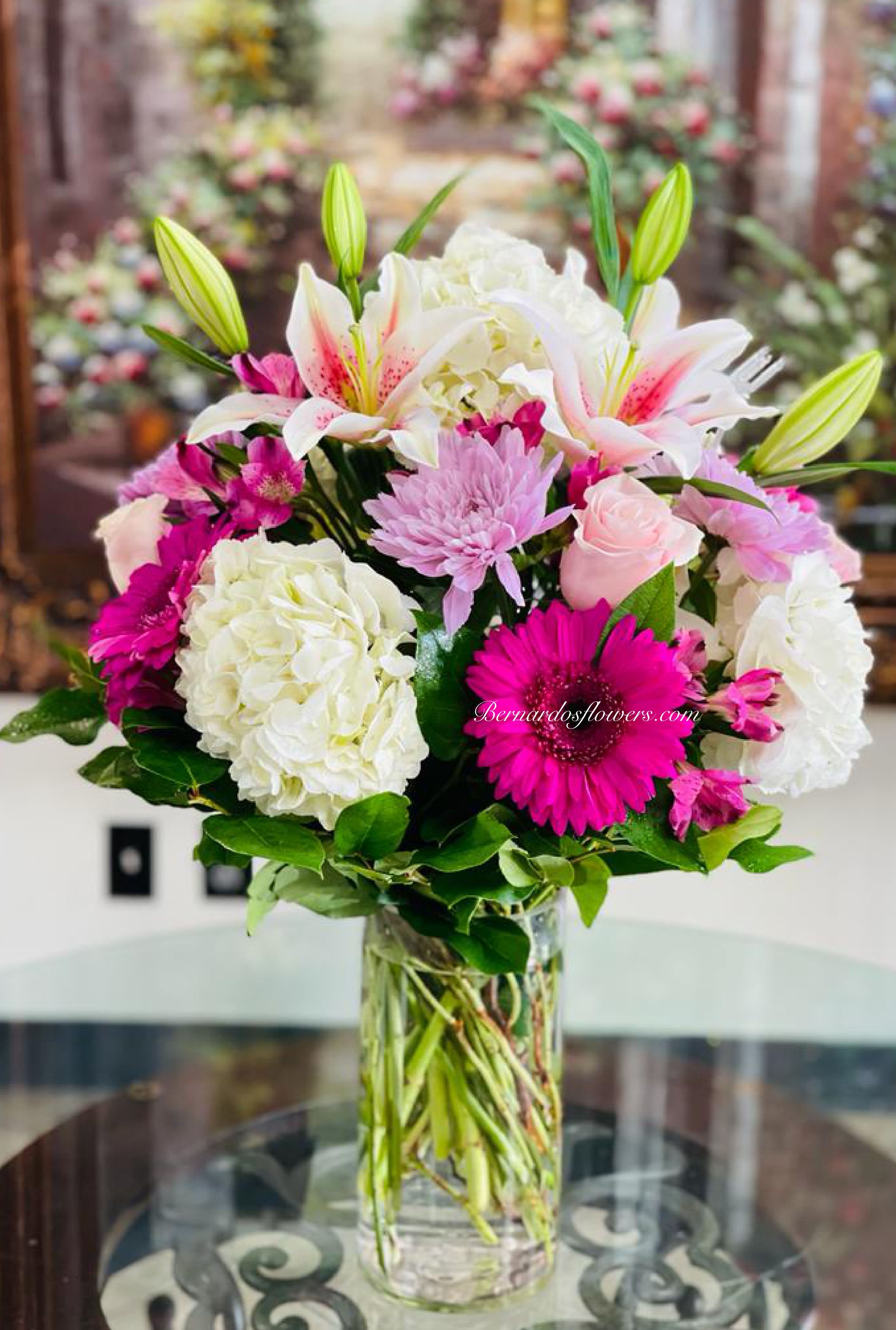 Pink and white mixed bouquet in a clear glass vase