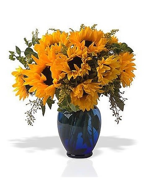 Sunny Sunflowers - These vibrant sunflowers arranged with eucalyptus leaves in a glass vase is a great way to brighten up anyone's day! 