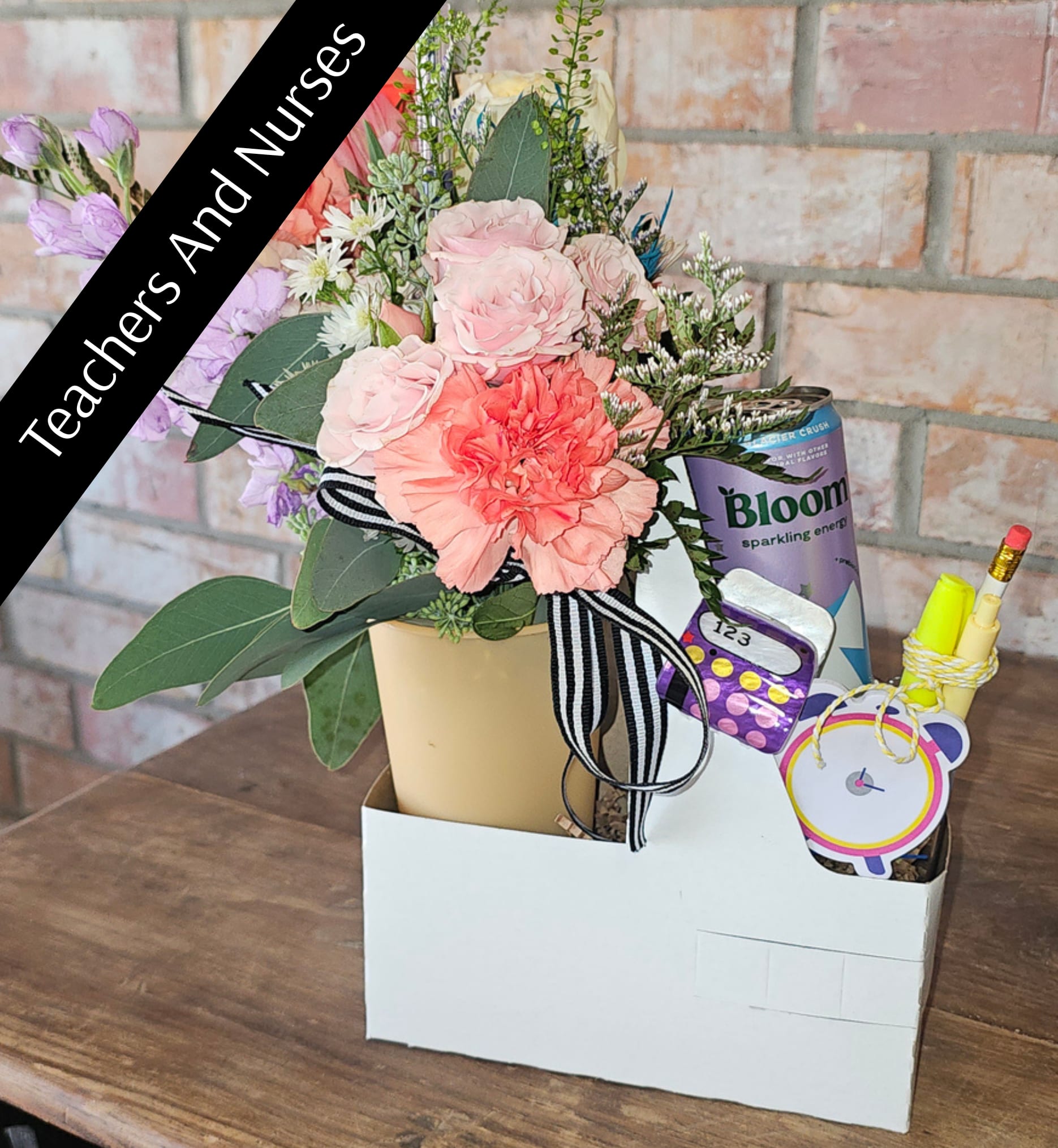 The Bloom Break  - The Bloom Break is a thoughtfully curated floral experience designed to bring a little joy into the middle of a busy day. Featuring a designer’s choice mini bouquet paired with a refreshing beverage and small treats, this piece is equal parts uplifting and intentional.  Whether you’re sending encouragement, celebrating a small win, or reminding someone (or yourself) to take a break — this arrangement delivers more than flowers. It delivers a moment.  Each Bloom Break is created using fresh, seasonal florals and may vary slightly in color and selection, ensuring every design feels unique and personal. Beverage and treat selections may vary based on availability.  What’s Included: • Designer’s choice mini bouquet • Keepsake tumbler with lid &amp; straw • Beverage (canned latte, iced coffee, or energy drink — selection may vary) • Sweet &amp; savory treat • Mini notebook &amp; pen • Gift-ready carrier