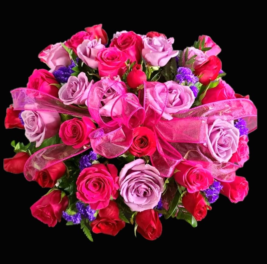 Bouquet of pink and red roses with a pink ribbon bow
