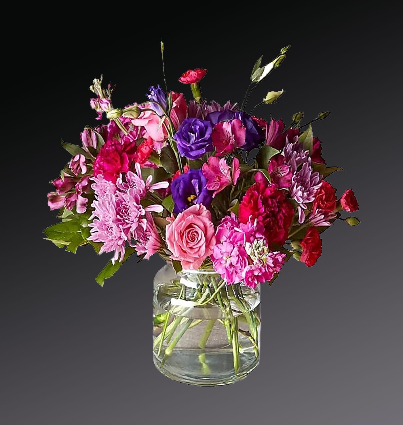 Mixed pink and purple bouquet in a clear glass vase