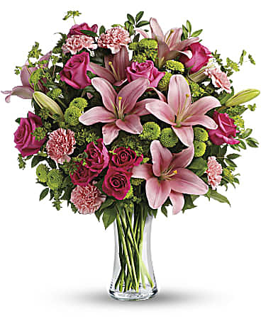 Dressed To Impress Bouquet - What's better than pink? More pink! This blissful bouquet of roses and lilies is arranged and delivered by a local florist in a classic glass vase. This flower arrangement is sure to put some pink in their cheeks and a smile on their faces! What's better than pink? More pink! This blissful bouquet of roses and lilies is arranged and delivered by a local florist in a classic glass vase. This flower arrangement is sure to put some pink in their cheeks and a smile on their faces! Orientation: One-Sided