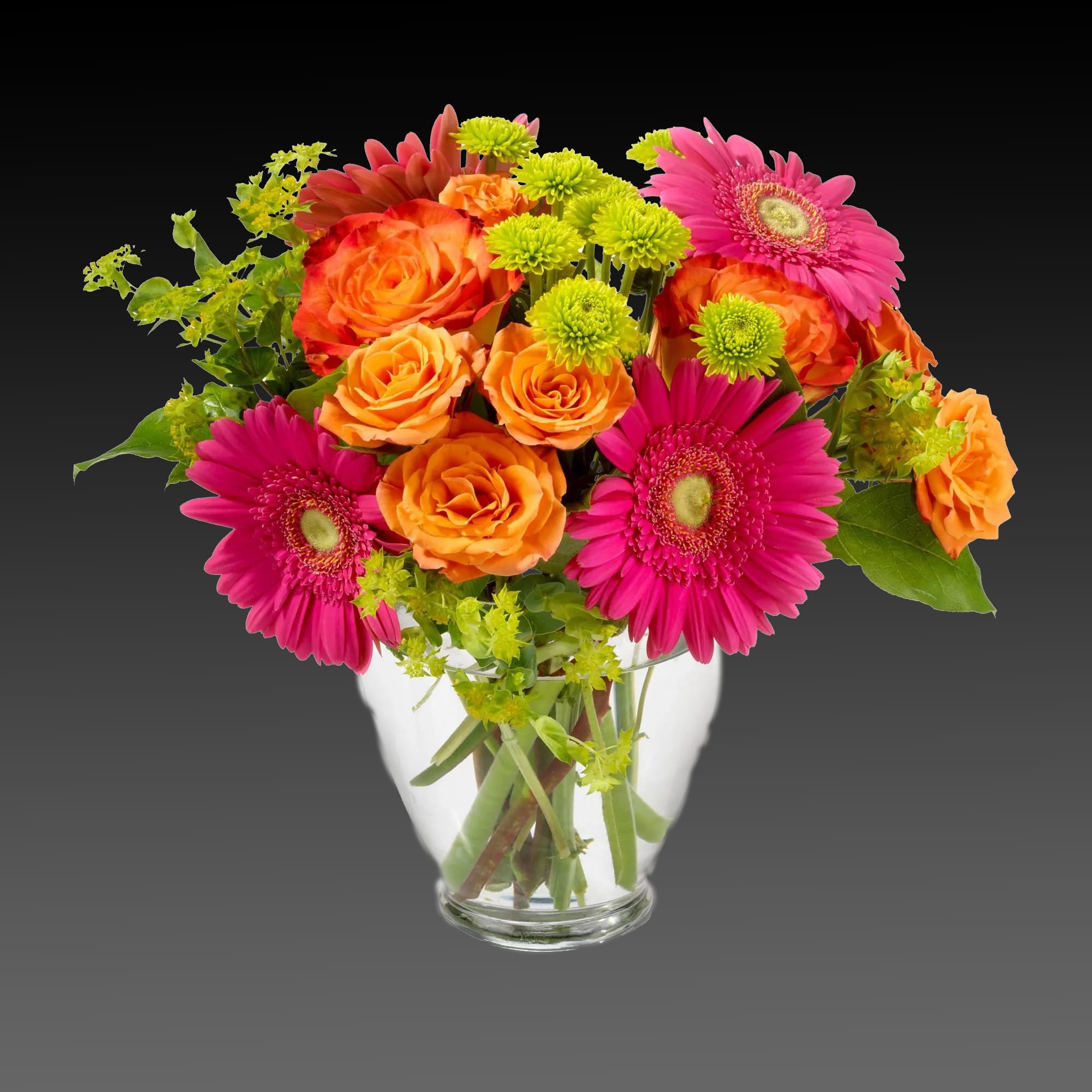 Bouquet of orange roses and pink gerbera daisies in a clear glass vase