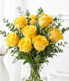 Yellow Rose Bouquet - Sunny yellow roses are a cheery and wonderful gift. Celebrate a birthday anniversary graduation or any occasion with this lively bouquet arranged with delicate greens in a clear glass vase. Vase style may vary
