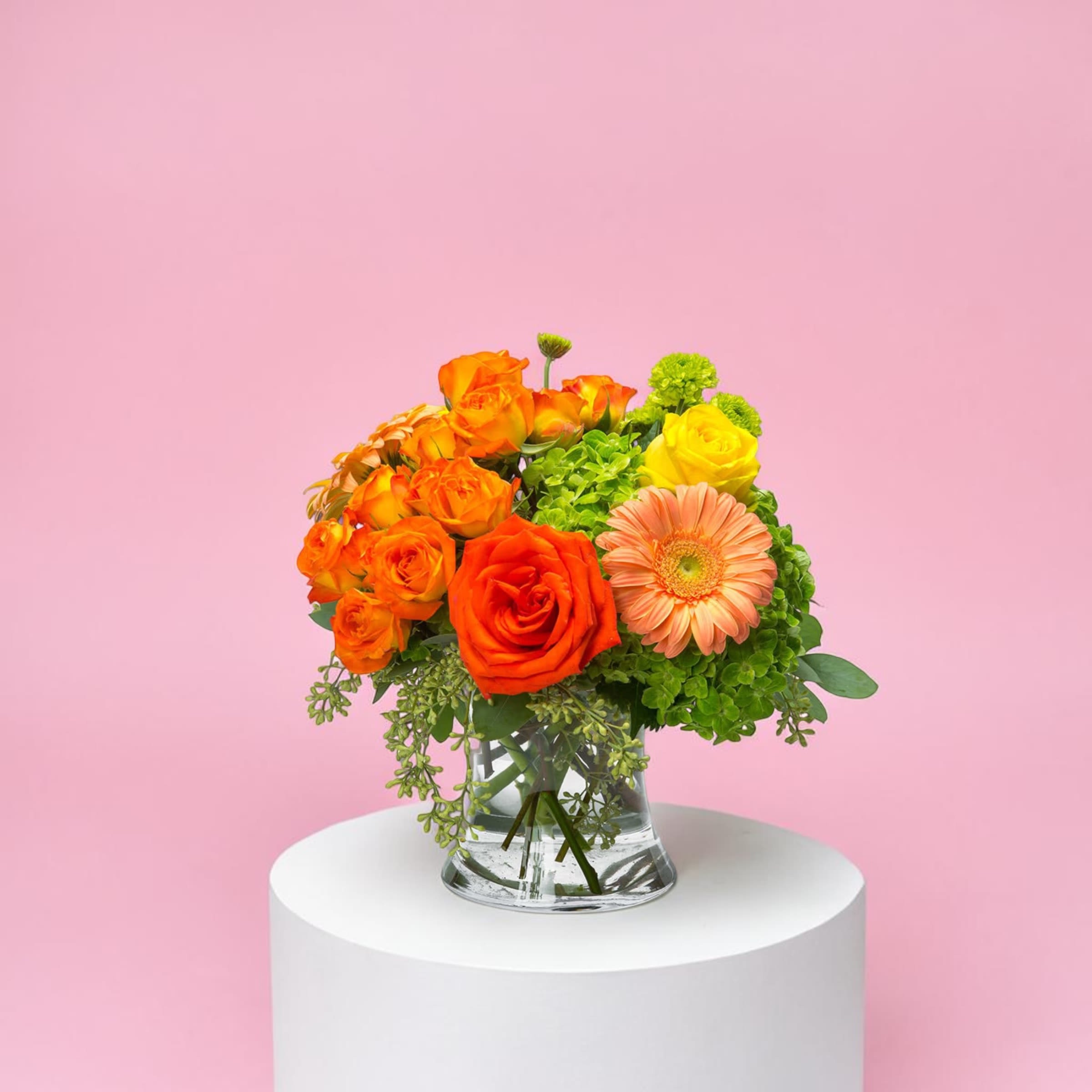 Bright Morning by BloomNation™ - Pink, yellow and orange roses come together with green hydrangea for a bright cube of sunshine. This arrangement lights up any space and will improve anybody's day. A perfect gift for all occasions.   APPROXIMATE DIMENSIONS 10" W X 11" H 