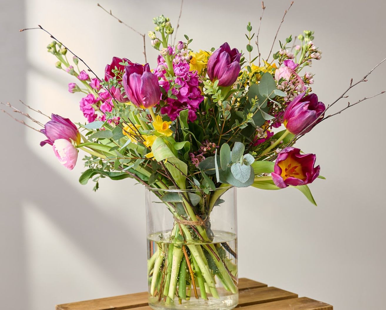 Happy Face in a Vase - A vibrant burst of joy, Happy Face in a Vase brings together bold magenta or rich purple, and sunny yellow blooms in a playful, uplifting design.   This arrangement is all about energy and positivity—perfect for birthdays, celebrations, or simply brightening someone’s day.