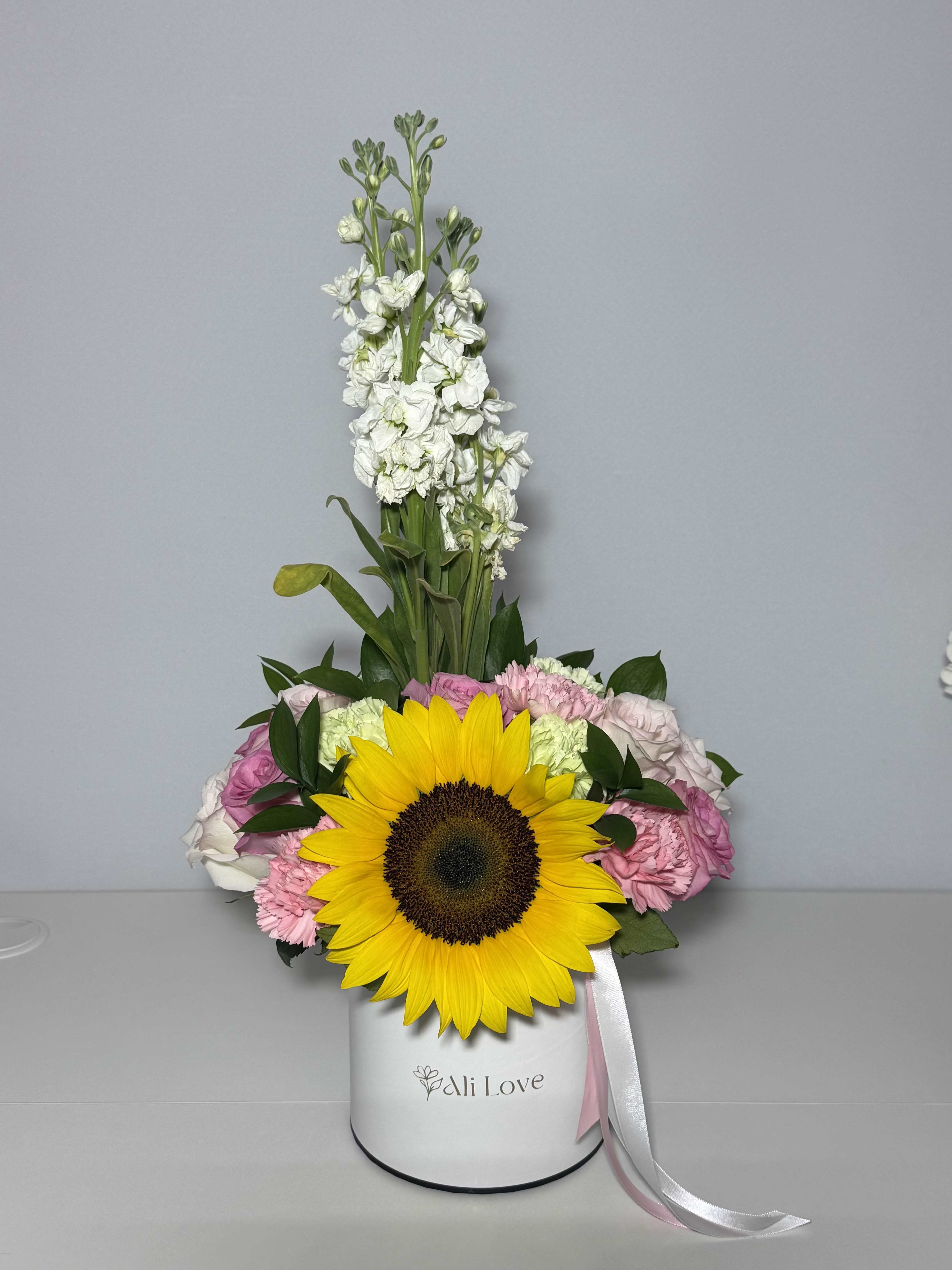 Margarita - A Mother’s Day arrangement made with so much love . Sunflowers, carnations, roses, and stock flowers all together in one bright, fresh bouquet. Something simple, beautiful, and made to make her smile the moment she sees it