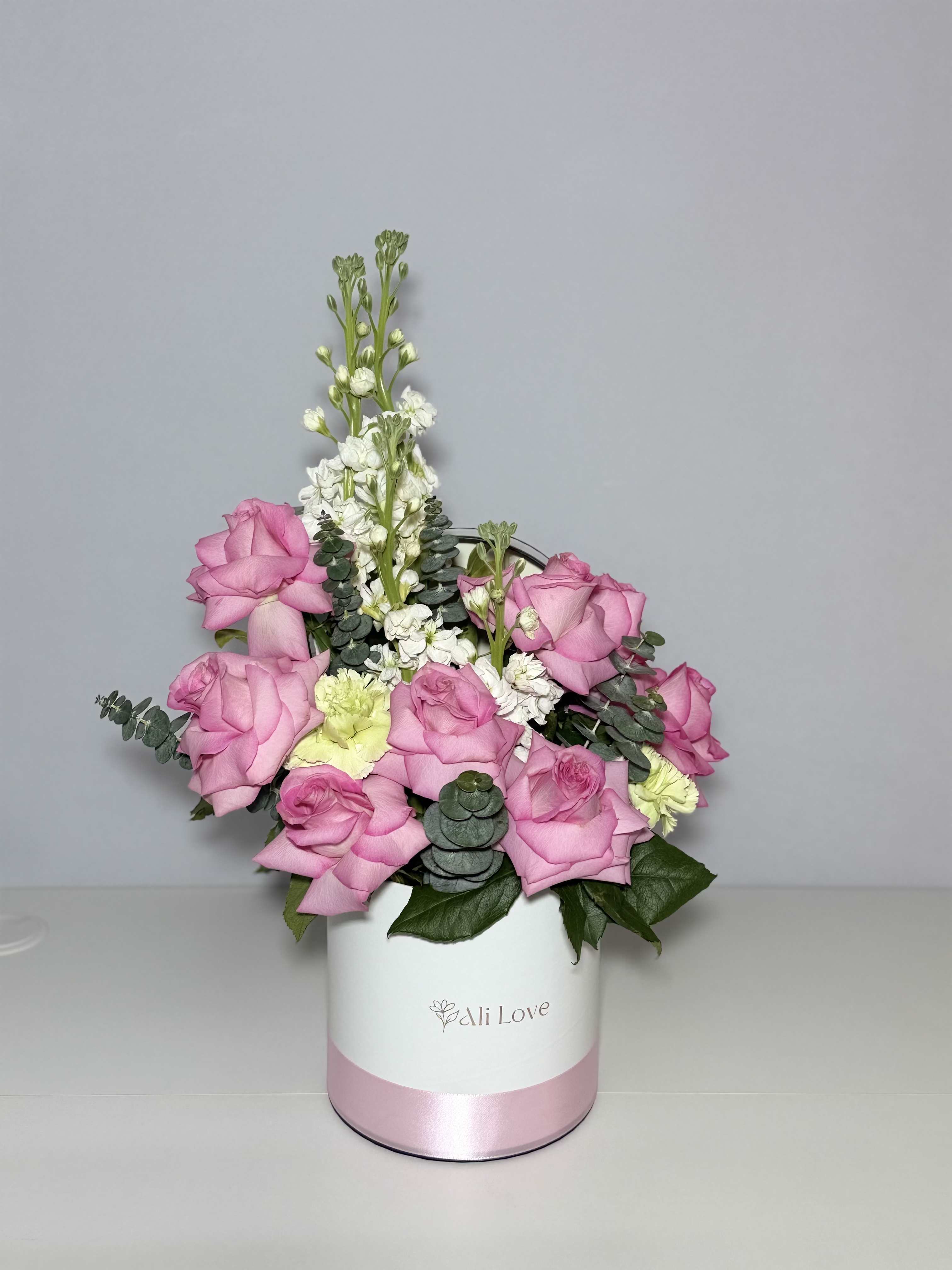 Lilia - A delicate and elegant bouquet of soft pink roses and stock flowers.. Simple, graceful, and made to feel special.