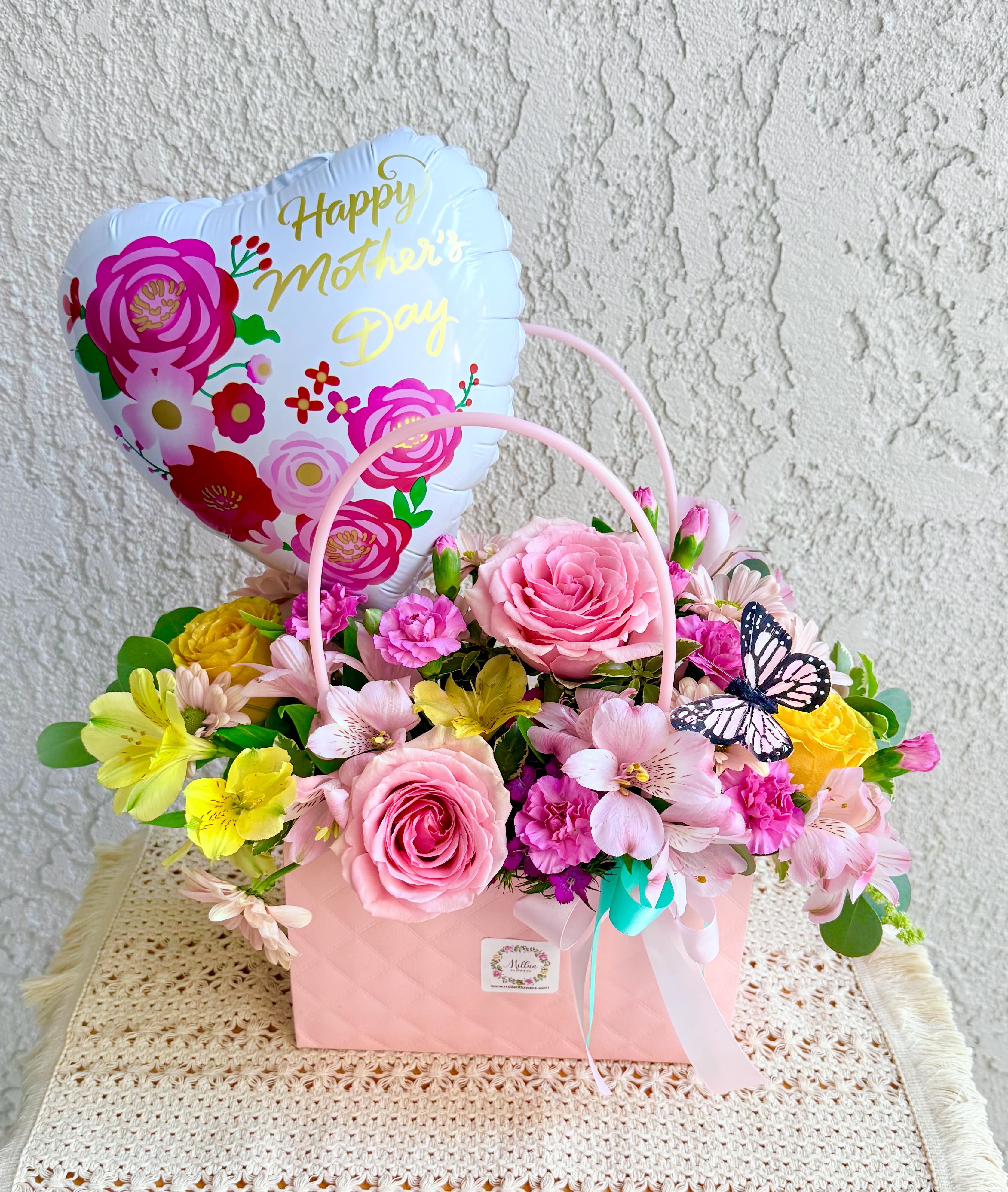 Mom's Favorite Floral  Purse - Beautiful floral purse crafted with Ecuadorian roses,  fancy mini carnations, fine alstromerias, seasonal foliage and  pom pom daisies. Size is medium It includes a beautiful mother's day balloon. The perfect Gift. A beautiful design.