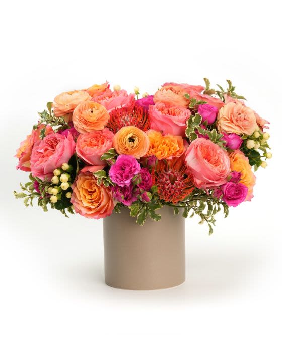 Enchanting Apricot - A lush mix of apricot, peach and pink blooms styled with fresh greenery for a rich garden inspired look.