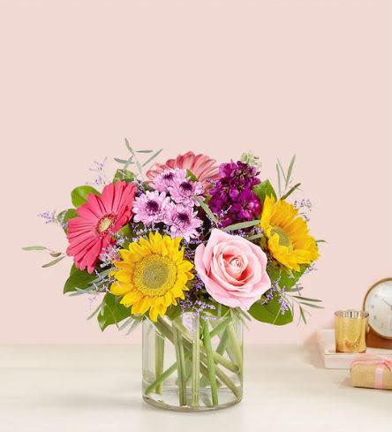 Garden Sensation   -  Pet Friendly? No .This arrangement contains Eucalyptus, Chrysanthemums (Daisy Mums), and Daisies, which can be toxic to cats, dogs, and other household pets if ingested. Keep this vase on a high shelf or in a room where curious cats cannot access the water or foliage.   Human Allergy Note This bouquet contains high-pollen flowers including Sunflowers and Daisies. To minimize irritation, keep the arrangement in a well-ventilated area and away from bedside tables or areas where people sleep.   Care &amp; Longevity To keep your blooms fresh, trim the stems at a 45-degree angle before placing them in the vase. Ensure the glass cylinder is filled with cool, clean water and change the water entirely every two days. Keep the flowers away from direct sunlight, heating vents, and ripening fruit to prevent premature wilting.   Best Occasions &amp; Situations  Bright birthday surprise  Graduation or promotion celebration  Cheerful get-well gesture  Colorful housewarming gift  “Thinking of you” during summer  Hostess gift for a garden party  Father’s Day  Mother's Day  Why Customers Love It Vibrant color palette that instantly brightens any room. Textured variety of blooms creates a high-end, professional look. Sturdy vase included for a gift-ready presentation. Long-lasting filler flowers like Limonium keep the look full for days. Versatile design suitable for almost any celebratory occasion.