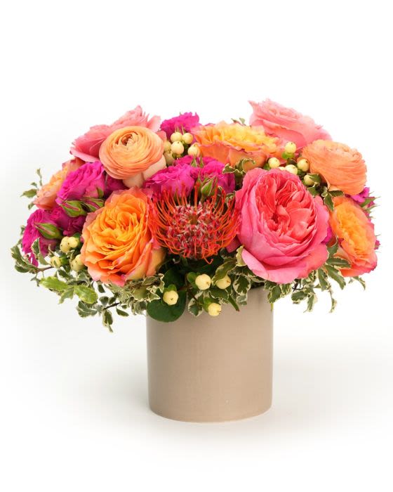 Apricot Nectar - A glowing mix of apricot, peach, and pink blooms, styled with fresh greenery in an elegant garden design