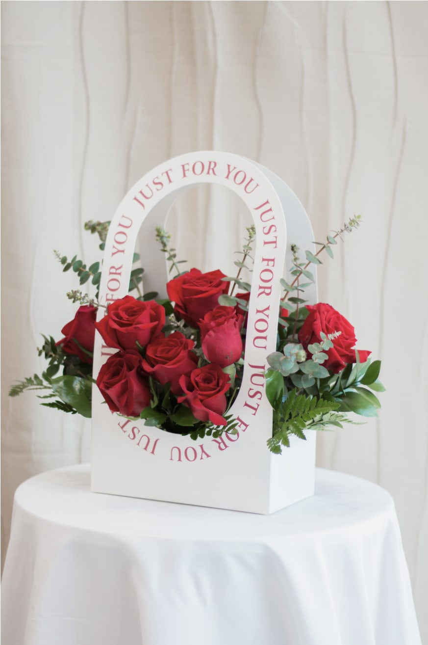 Wonderful Mama - Celebrate Mom in full color with Wonderful Mama. This eye-catching purse arrangement bursts with rich fuchsia roses and spray roses, symbolizing love, appreciation, and happiness. A fun and modern design that makes her feel as special as she truly is.