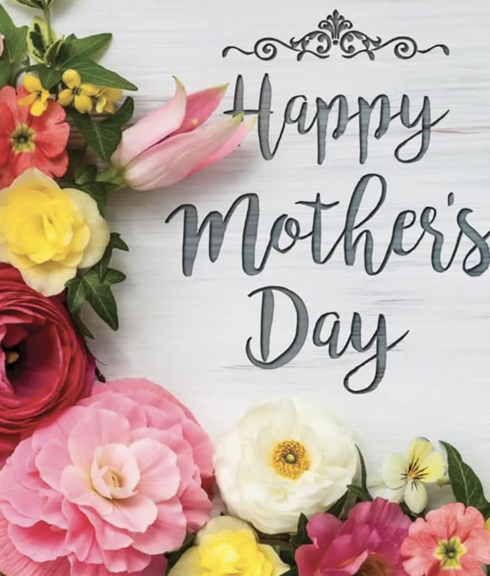 Colorful flower arrangement around a "Happy Mother's Day" sign
