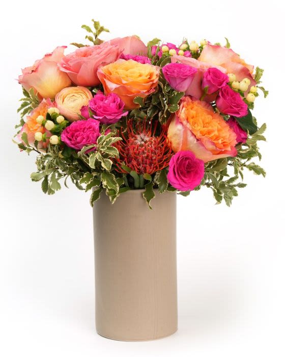 Sunlit Garden - Soft, pink, and golden blooms arranged with fresh greenery for a bright, sunlit garden feel. 