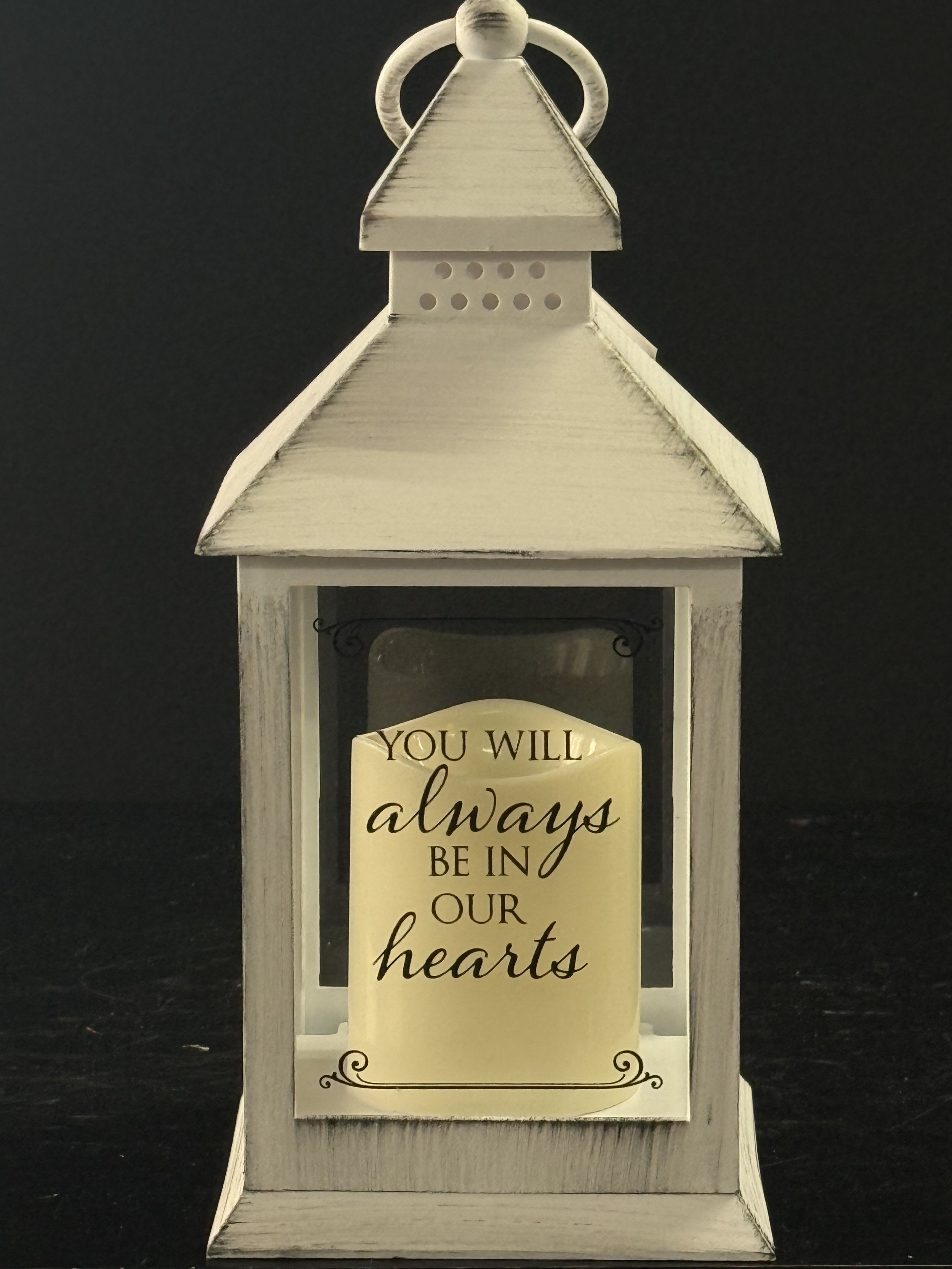 White lantern with a memorial message card inside