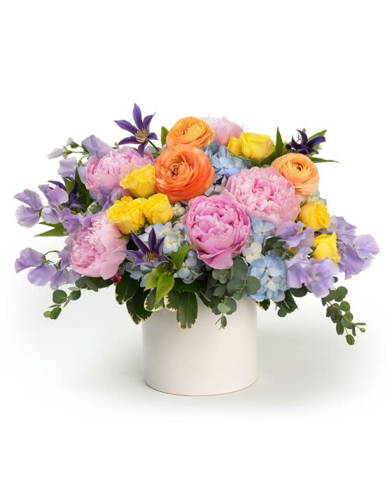 Spring Abudance - A luxurious mix of peonies and specialty European garden blooms in soft pastels designed with full texture and elegant movement.