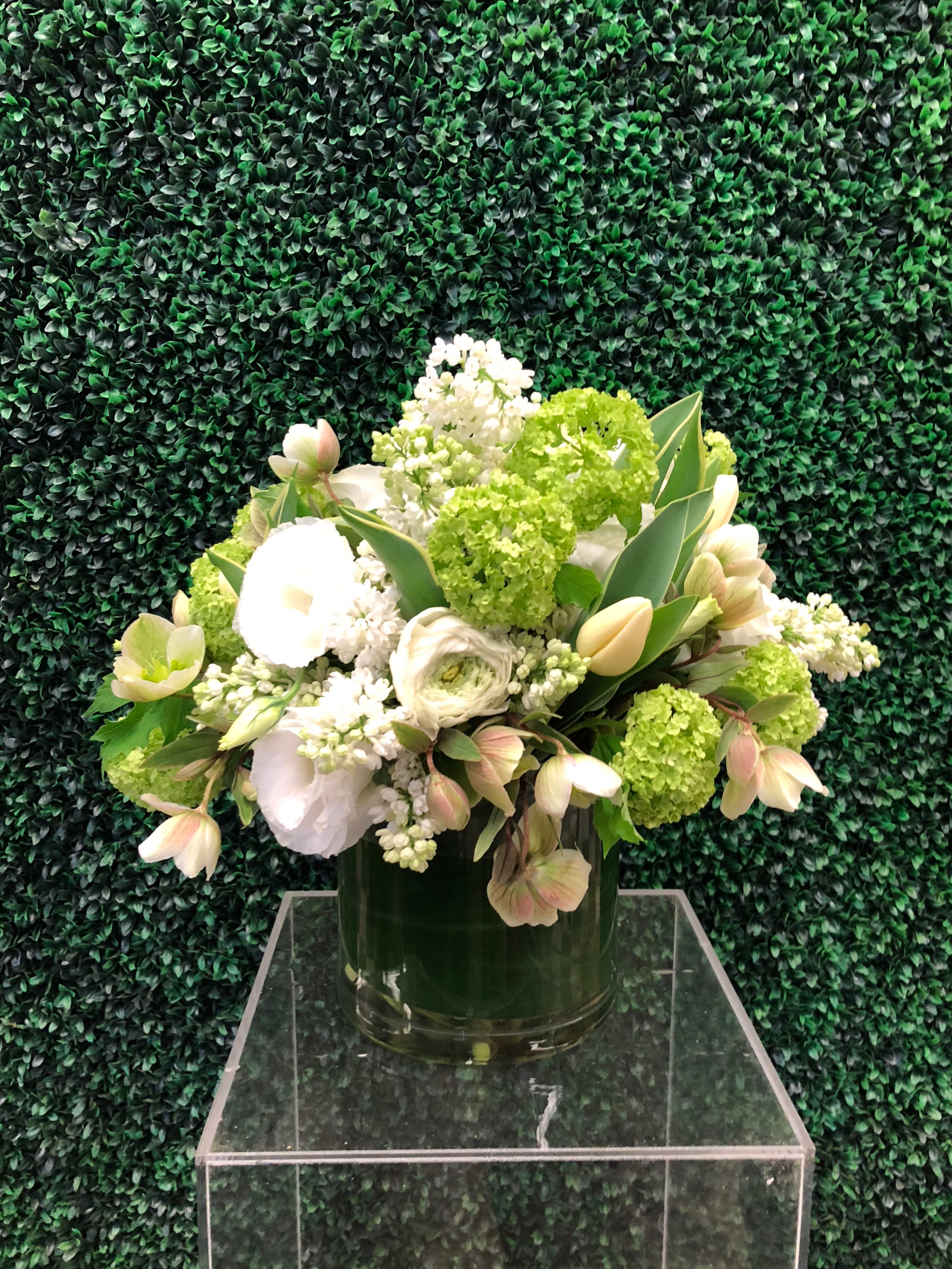 Summery Greens and Whites - A Luscious spring arrangement in shades of tart lime green and lush white blooms arranged in a leaf lined glass cylinder.