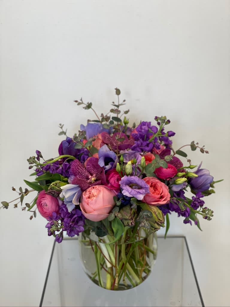 Mixed purple and pink bouquet in a clear glass vase
