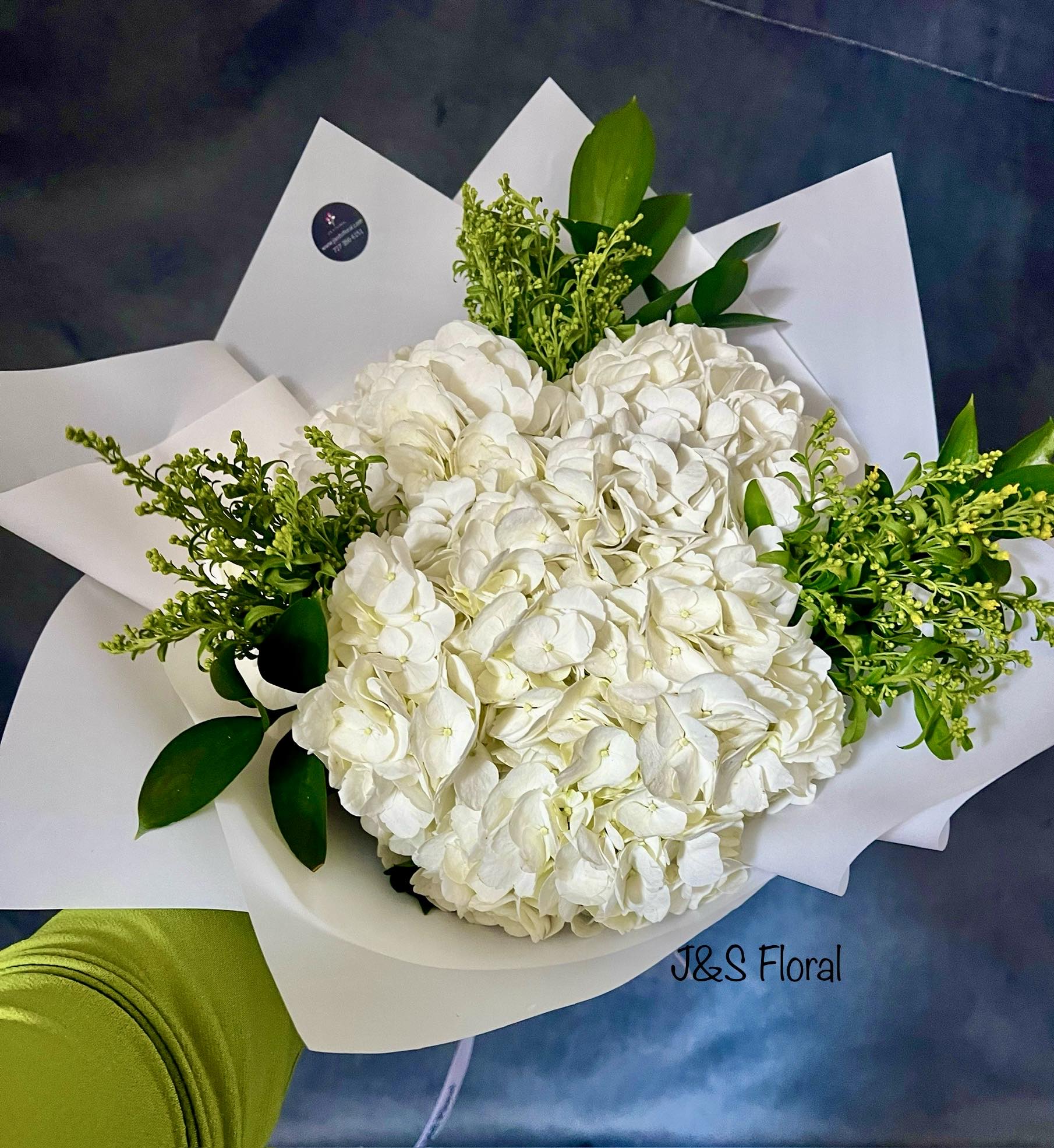 White hydrangea bouquet with green filler and white wrapping