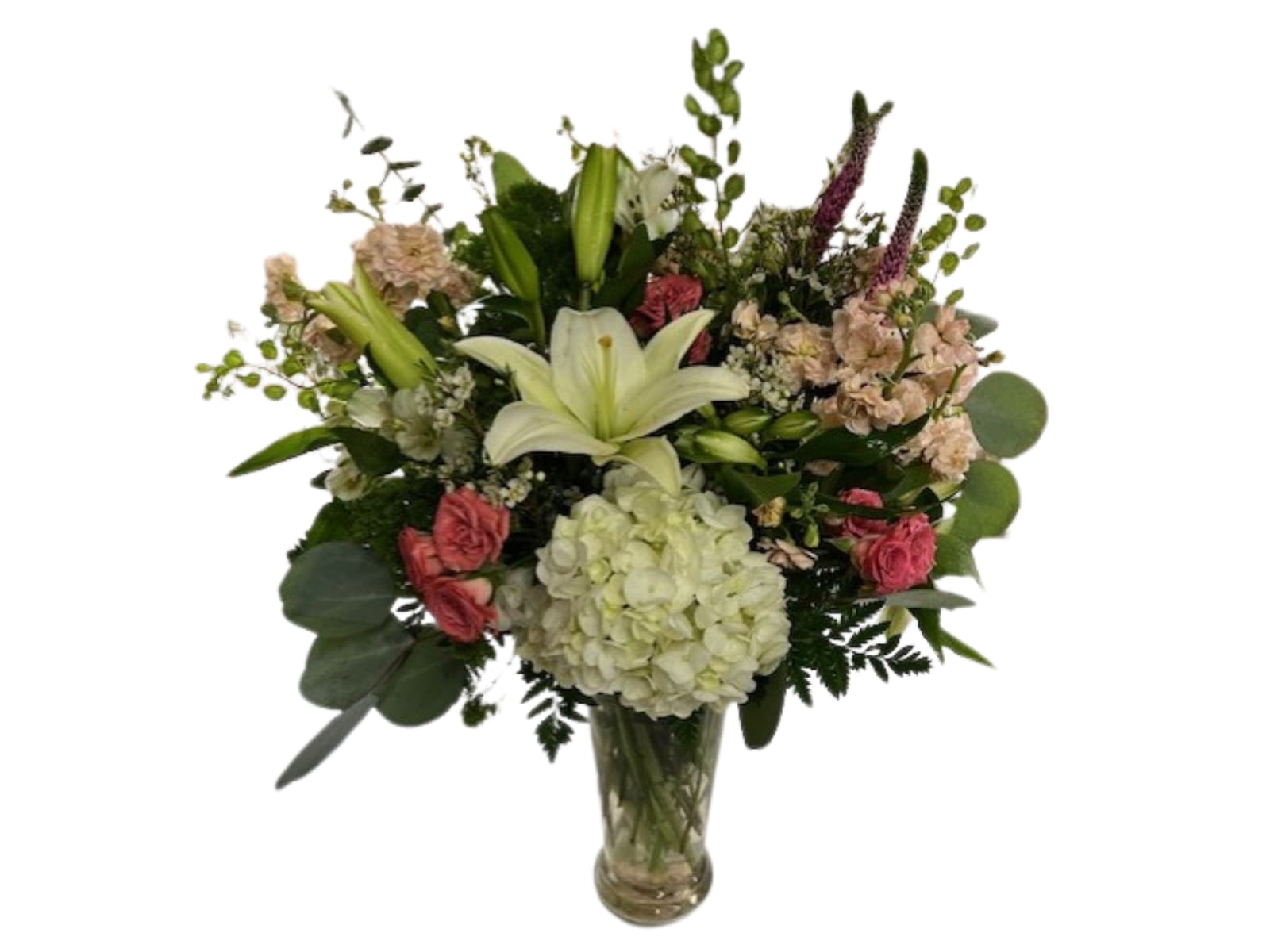 Bouquet of lilies, hydrangea, and pink flowers in a glass vase