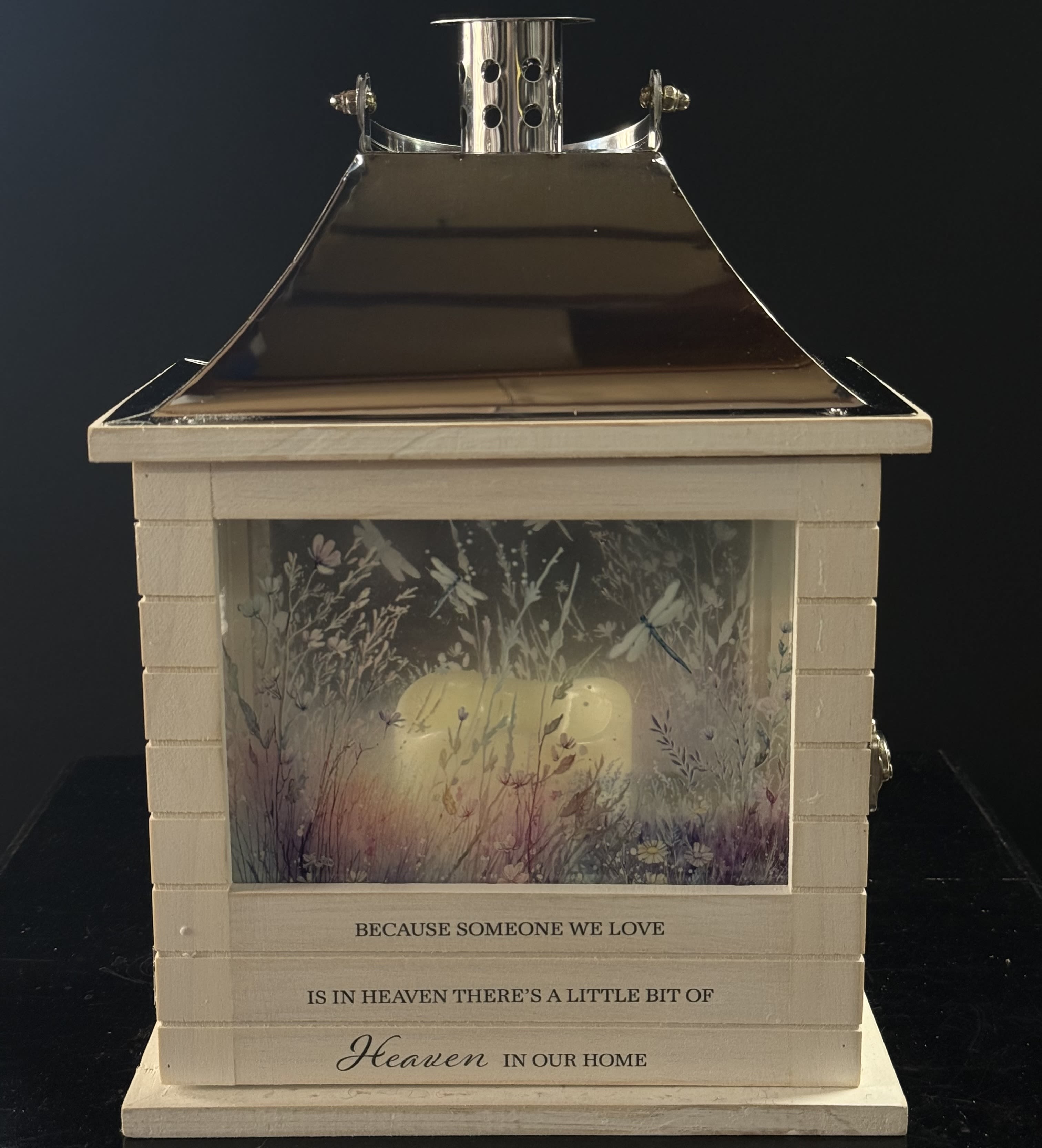 Decorative memorial lantern with a candle inside and floral artwork