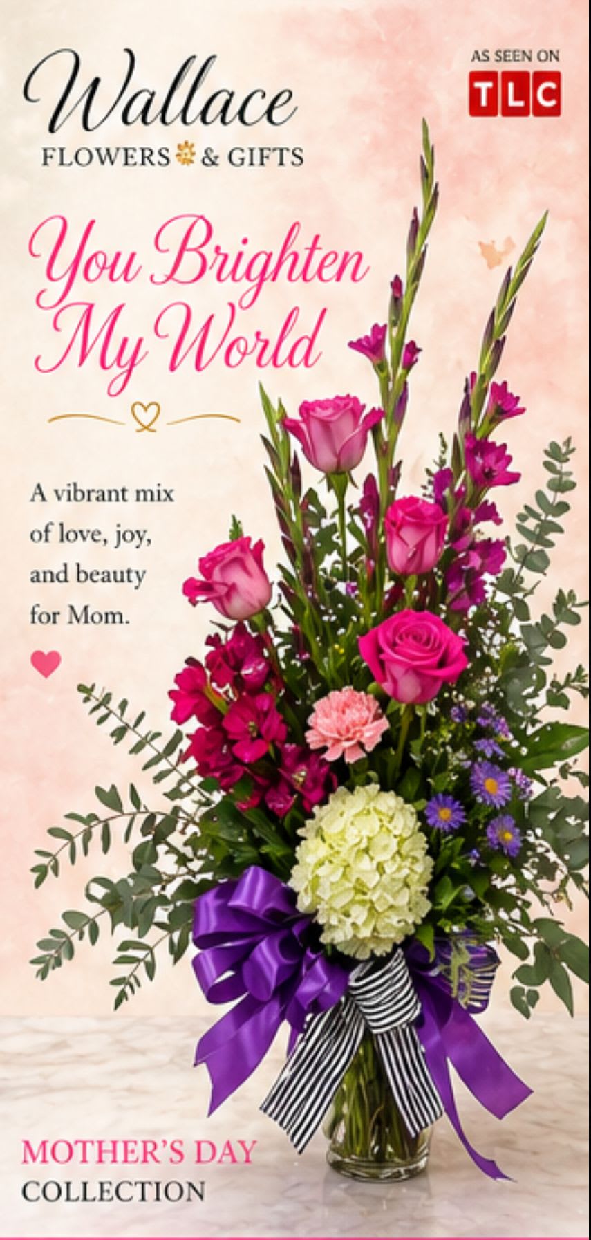 You Brighten My World  - A bright, feminine bouquet that feels made for Mother's Day or any celebration where you want to make her feel truly seen-the tall, layered "You Brighten My World" arrangement brings pink, purple, white, and green together in an uplifting display. This birthday bouquet or Mother's Day arrangement reads as joyful and elegant: soft roses and ruffled carnations mingle with alstroemeria and chrysanthemums, while purple daisy-like asters and airy eucalyptus-style foliage add texture and movement that catch the eye.  The clear glass vase showcases the long stems and gives the design a light, airy silhouette; a large purple ribbon and a black-and-white striped accent ribbon dress the base for a polished, gift-ready presentation. Expect a mix of round rose heads, full carnation blooms, starry alstroemeria clusters, and daisy-like asters in complementary pinks, purples and crisp white, with green foliage to frame each bloom.  Perfect for mom, a teacher, or someone who brightens your day, this arrangement reads as celebratory, thoughtful, and cheerfully sophisticated-the kind of bouquet that makes the recipient feel genuinely celebrated. Care: keep in fresh water, trim stems and remove foliage below the waterline, and display in a cool spot away from direct sun to extend bloom life.