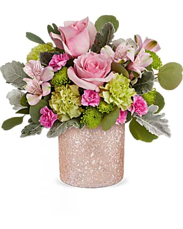 Pink roses and mixed blooms in a glittery vase