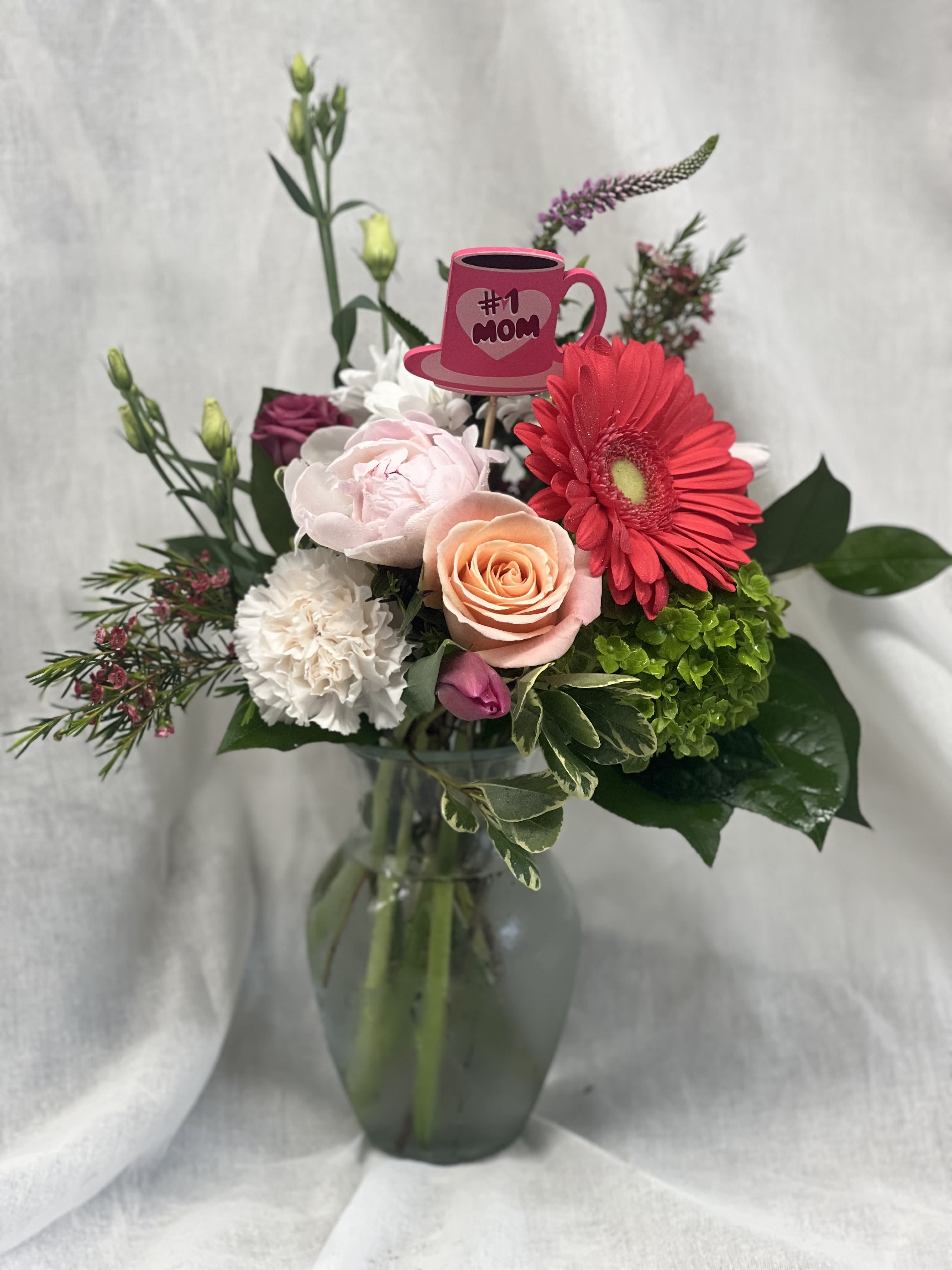 Mixed bouquet in a glass vase with a pink "#1 Mom" pick